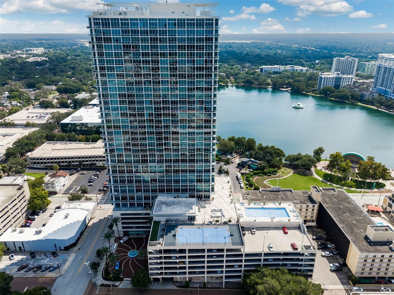 This Distinguished Condo speaks for itself! No expense was spared on the new finishes. Unit 1612 at The VUE at Lake Eola is a 1,285-square-foot Luxury Corner unit on the 16th floor, featuring 2 bedrooms and 2 bathrooms. It recently underwent a full remodel with high-end finishes and offers unobstructed city views with floor-to-ceiling windows. The unit has been renovated with a focus on modern elegance and high-end materials: Flooring: Gleaming white Italian porcelain tile throughout.Gourmet Kitchen: Fully upgraded open-concept kitchen with a gas stove, new stainless steel appliances, quartz countertops, custom European cabinetry, and designer finishes. High-End Designer Lighting throughout.  Primary Suite: Includes custom double walk-in closets and a modernized ensuite bathroom with dual sinks and a spa-inspired design.Technology & Comfort: Equipped with electronic blinds in the living area, 10' high ceilings, and a private balcony. On-Site Storage, Cable TV, WiFi, and more. The Vue at Lake Eola offers a luxurious, modern high-rise living experience in Downtown Orlando, boasting breathtaking views, upscale amenities, and a prime location for residents to enjoy the best the city has to offer. The luxury building features a lavish lobby staffed with 24/Hr Security, Concierge, Valet parking, Jr. Olympic-size Rooftop Pool, Multi-million Dollar Health Club, Tennis/Basketball Court, Private Media Room, Dog Walk, and the Club Vue Lounge, which is exclusively for Residents and Their Guests. There is also Resident only Bio metric Fingerprint Access, which will ensure a SAFE and Private Environment. Outdoor Recreation: Directly adjacent to Lake Eola Park, home to a 1-mile walking loop and the weekly Orlando Farmers Market.Convenience: Within walking distance of a Publix grocery store, the Dr. Phillips Center for the Performing Arts, and various dining and nightlife options at Wall Street Plaza.Parking: Unit 1612 includes two reserved parking spots in the secured garage with valet service.