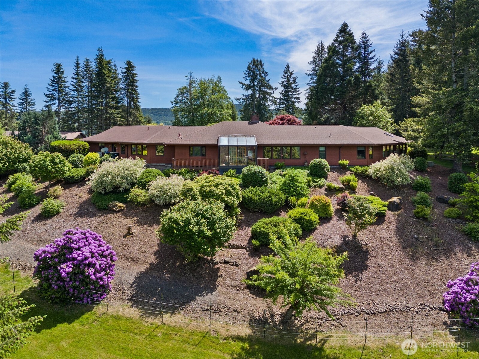 Discover comfort, luxury, and country living on this stunning property offering over 3,100 sq. ft. of spacious living. The beautifully updated kitchen features custom granite countertops and top-of-the-line appliances, while the 5 bedrooms and 2.75 baths provide plenty of room for everyone. The exceptional primary suite and beautifully updated bath with Jacuzzi-brand fixtures create a relaxing private retreat.  Enjoy breathtaking views from nearly every room, then step outside to a beautifully landscaped, park-like setting. The fully fenced property is thoughtfully designed for hobby farming and outdoor living, featuring a detached shop, RV parking, and a barn equipped with Powder River gates and livestock chutes. Three separate pastures provide ample space for animals, while in-ground sprinklers, electricity to all outbuildings, and water to all troughs add convenience and functionality. Adjacent to this amazing property is an amazing indoor arena.  Every detail has been thoughtfully considered to create your own private oasis. With space, amenities, and endless possibilities for hobby farming and country living. Just minutes to the Lakes for summer fun and close to skiing for Winter activities this exceptional property is truly a must-see. Contact your favorite Broker to view this one, you will not be disappointed.