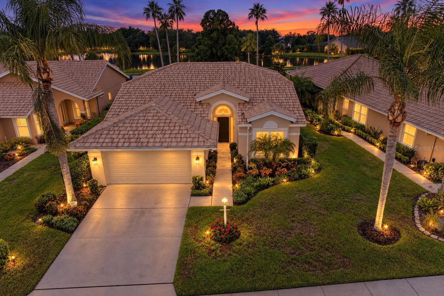 Enjoy MAINTENANCE-FREE living in the highly desirable River Club GOLF COMMUNITY located in Bradenton, FL. This UPDATED 3-bedroom, 2-bathroom Arthur Rutenberg home offers all the modern conveniences of Lakewood Ranch without the excessive fees…thanks to LOW HOA dues and NO CDD fees. Inside, you'll immediately notice the porcelain tile flooring throughout the main living areas, as well as the updated kitchen with newer stainless-steel appliances, gorgeous cabinetry with under-cabinet lighting, and granite countertops. Both bathrooms have also been beautifully remodeled. However, the home’s true standout feature is the expanded Florida Room, created by converting the original lanai into a spacious, enclosed, air-conditioned living area where you can relax and enjoy LAKE VIEWS all year-round. Prefer fresh air? The adjacent back porch provides the perfect spot for morning coffee, evening drinks, or grilling with family and friends, and the electric retractable awning provides added shade and comfort. The third bedroom, currently being used as an office, also overlooks the lake and features attractive laminate flooring plus a Murphy-Bed, offering flexible space for guests, work, or hobbies. Peace of mind is another important feature with IMPACT WINDOWS AND DOORS providing added storm protection while also helping with energy efficiency and insurance costs. The home did NOT experience flooding during the major storms of recent years, and a generator hookup is in place for convenient backup power should it ever be needed. Additional upgrades include a freshly painted interior (2023) and exterior (2025), custom designed closets, a new motor in the AC compressor, a stunning epoxy garage floor, and elegant exterior landscape lighting. Located near The River Club Golf Course, this home offers the lifestyle of a golf community with NO MANDATORY GOLF MEMBERSHIP. You'll also be just minutes from Lakewood Ranch Main Street, Waterside Place, and UTC Mall, giving you convenient access to shopping, dining, entertainment, community events, and more. If you’re looking for a maintenance-free home in the Lakewood Ranch area, put this one on your MUST-SEE list as homes in this condition, in this location, AT THIS PRICE, don’t come on the market often. Call today to schedule your showing.