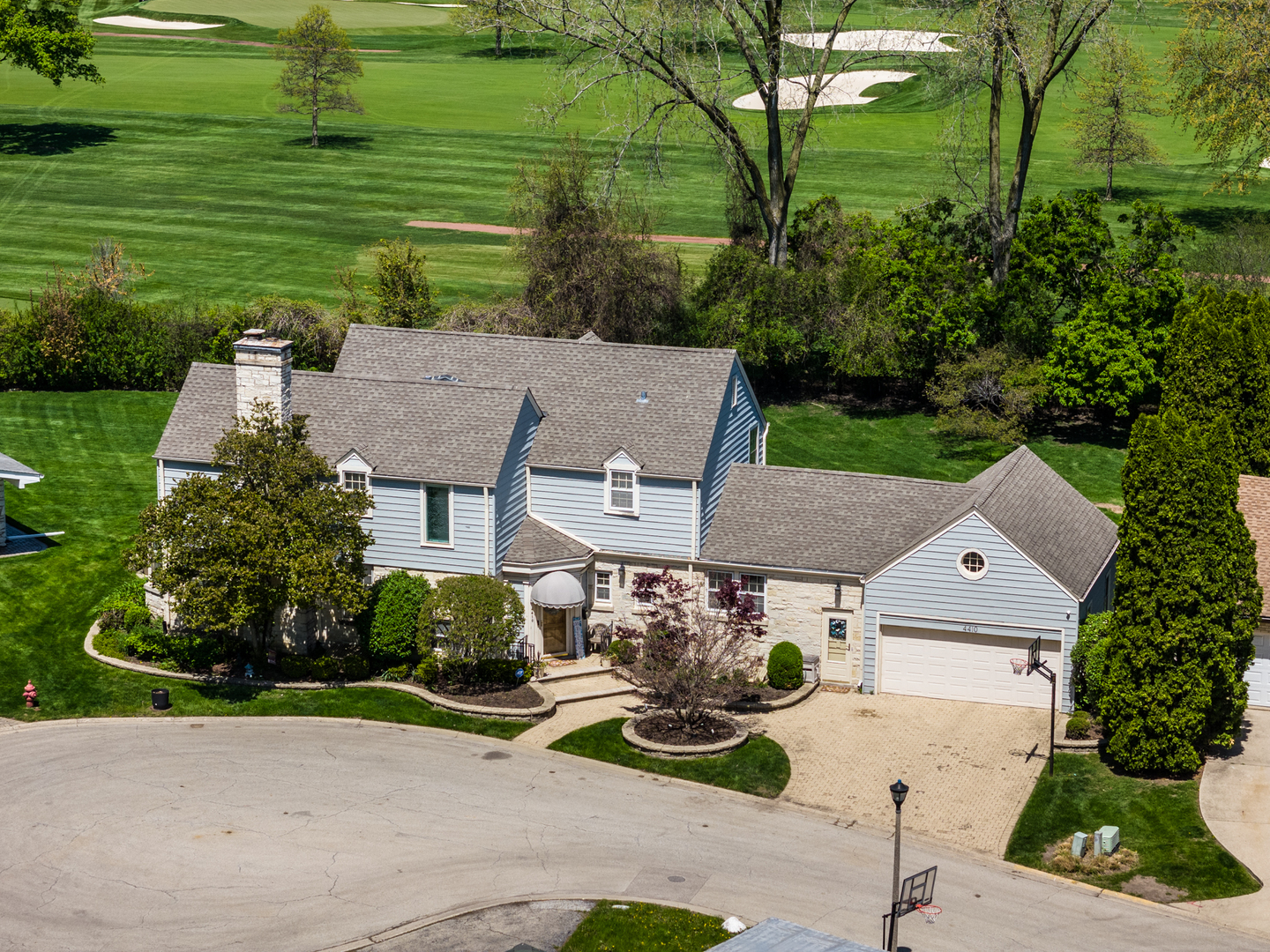 Come and see this elegant home with golf course views in a prime Skokie location. If you love to golf-or simply enjoy the beauty of open green space-this is your opportunity to own a gracious home overlooking the scenic Evanston Golf Course. Perfectly situated for comfort, entertaining, and family life, this spacious residence offers timeless charm and exceptional functionality. Step inside through a warm and welcoming entryway into an expansive living room featuring a cozy fireplace and enough space to accommodate a baby grand piano. The formal dining room, with its picture windows framing lush golf course views, provides a stunning backdrop for memorable gatherings. The generously sized kitchen is ideal for home chefs, offering two pantries, abundant counter space, and a casual dining area that looks out over the private backyard. An inviting wood-paneled den with built-in bookshelves doubles as a quiet library or home office. A bright sunroom at the rear of the home offers the perfect space for lounging, reading, or simply enjoying the view of the yard. The second floor features four comfortable bedrooms and two full bathrooms, providing ample space for family and guests. A convenient first-floor bedroom with an adjacent full bath adds flexibility for guests or multigenerational living. Beautiful circular staircases connect all three levels of the home. The finished basement includes a recreation room, a dedicated workout space, a half bath, and abundant storage in both the furnace and utility rooms. Step outside to a spacious patio ideal for al fresco dining and entertaining. The sun-drenched backyard offers plenty of room for a playset, garden, or both-creating your own private oasis just steps from the golf course. Located close to top-rated schools, shopping, restaurants, and public transportation, this home blends tranquility with urban convenience. Don't miss the chance to make this rare and refined property your own.