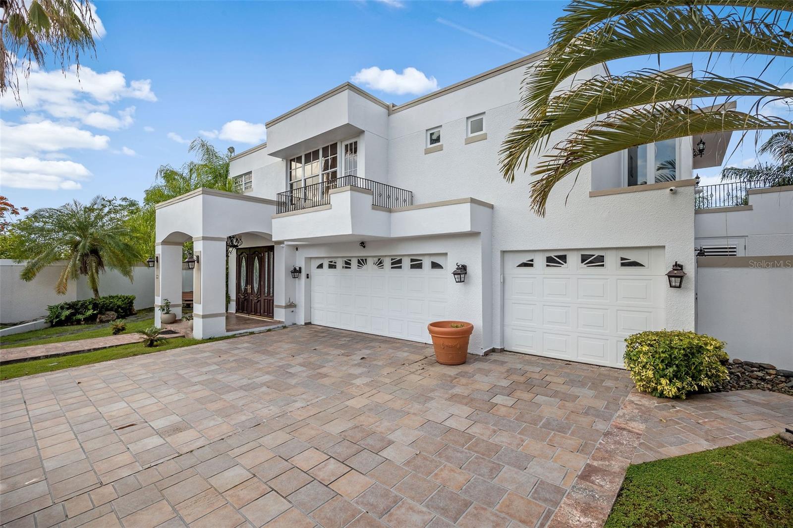 Located in Palma Real, this single-family residence is positioned on a cul-de-sac and sits on a wide lot with rear exposure to green area and the river that borders the community perimeter.The property offers 6 bedrooms, a den, and 5 full bathrooms plus 1 half bathroom. Interior layout allows for flexible use including office, media, or additional living space.Exterior features include an expansive terrace, gazebo, and outdoor kitchen area suitable for entertaining. The backyard is fully fenced and provides open green space with capacity for recreational use such as a volleyball area. A gated access point leads to additional land below with picnic tables and natural vegetation.Energy features include a solar panel system with net metering connected to the utility provider, along with battery backup consisting of three Tesla Powerwall units.Community amenities include pool, clubhouse, gym, gazebo, basketball court, tennis courts, pickleball, beach tennis, and playground.Property offers a combination of interior living space, outdoor areas, and energy infrastructure within a controlled-access residential community.