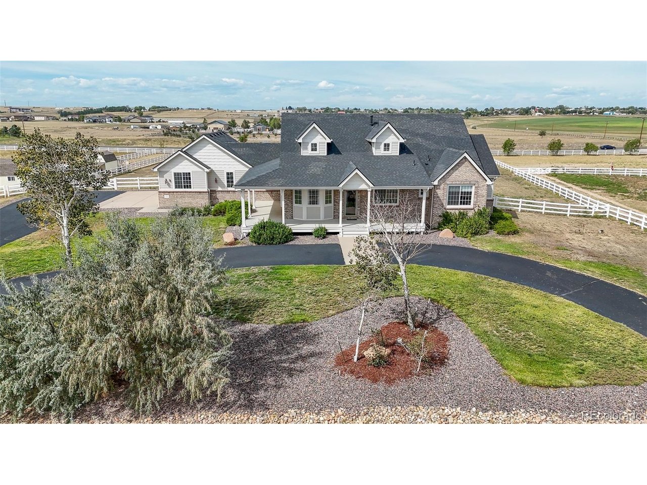 Welcome to Box Elder Estates- just East of Brighton, where acreage living, mountain views, and room to spread out come together! Situated on 2.06 acres, this impressive ranch offers 5,148 total sq. ft., 4 bedrooms, 5 bathrooms, a nearly finished full basement, and an oversized 3-car garage. Animals are allowed, with plenty of room for an outbuilding, RV, recreational toys, equipment, and more!A huge covered front porch welcomes you into a light-filled interior featuring hardwood floors, new carpet in areas of the main level, and spacious living areas. The great room offers abundant natural light, a cozy gas fireplace surrounded with built in's, and access through the french doors to the back deck where you can relax and take in the mountain views and beautiful sunsets.The open concept kitchen is made for gathering with granite countertops, beautiful custom cabinetry, and generous workspace and storage. The spacious primary suite offers a private retreat with a walk-in closet and 5-piece ensuite featuring a large jetted tub. Two additional main floor bedrooms and two more bathrooms provide plenty of room for guests and everyday living.The nearly finished basement adds incredible versatility with a fourth bedroom, two more bathrooms, a storage room, an office/den, and multiple flex spaces-ideal for a rec room, theater, gym, hobbies, homeschooling, working from home, or multi-generational living.Outside, enjoy over 2 acres to make your own, whether that means room for your toys, animals, gardens, an additional outbuilding, or simply more space and privacy. Served by a private well and septic, this unique Box Elder Estates property offers the freedom of country living with Brighton's amenities conveniently nearby.