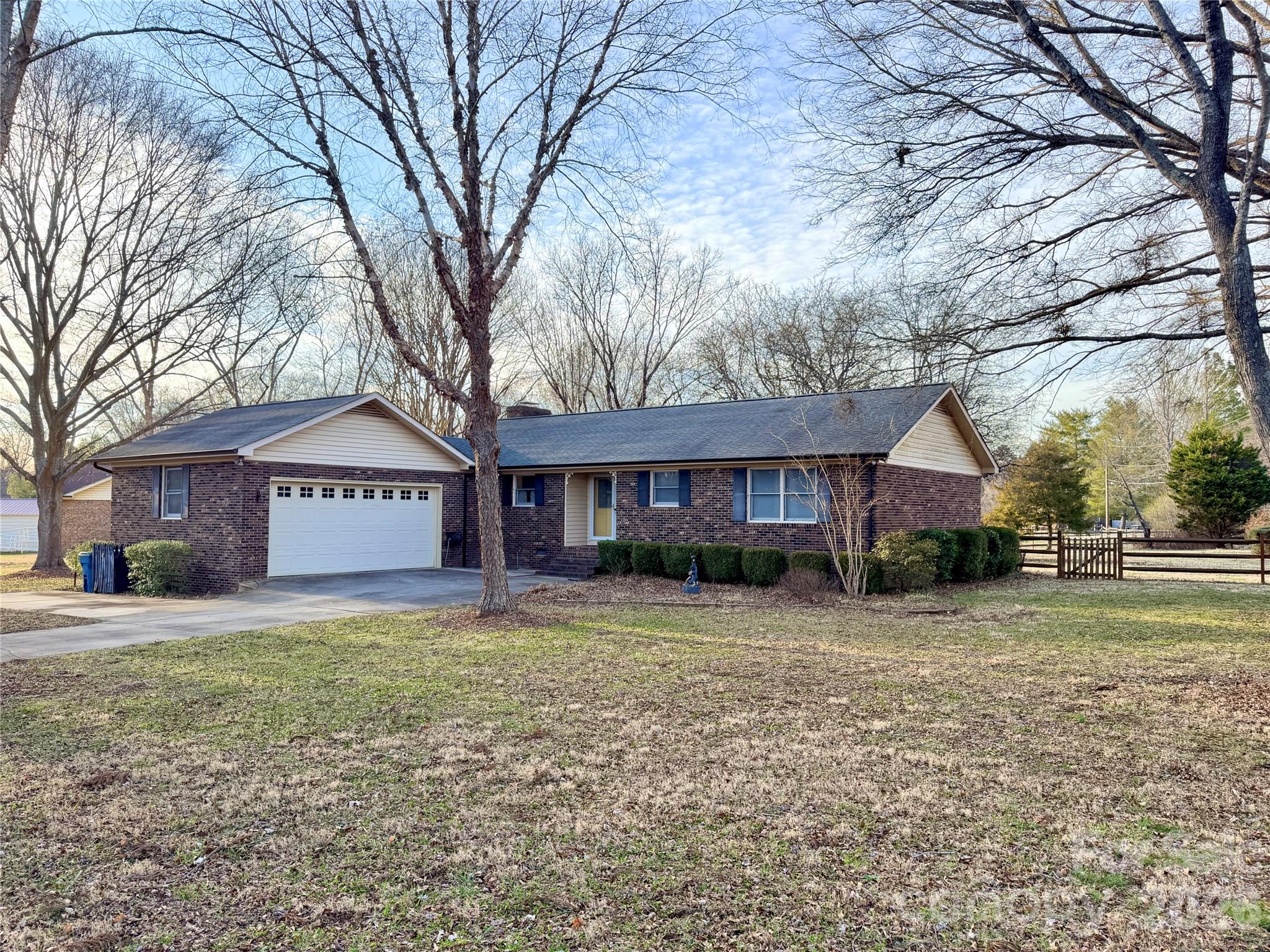 This charming 3-bedroom, 2-bath brick ranch sits on just over an acre in desirable Harrisburg!Nestled in an established neighborhood surrounded by mature trees, this property offers the perfect blend of space and serenity while still feeling like home from the moment you arrive.Inside, you’ll find hardwood floors throughout the bedrooms and a functional layout designed for comfortable everyday living. Each of the three bedrooms features a walk-in closet, providing ample storage. The kitchen and bathrooms are ready for your personal updates over time but are perfectly livable as-is — a wonderful opportunity to add your own style and build equity at your pace.The cozy living room showcases a beautiful stone fireplace, creating a warm and inviting gathering space (carpet update needed).Step outside to the screened-in porch and enjoy peaceful views of the spacious backyard year-round. An additional outbuilding offers excellent storage or workshop potential, adding even more versatility to the property.If you’re looking for space, privacy, and the chance to make a home truly your own, this brick ranch is full of opportunity and potential.