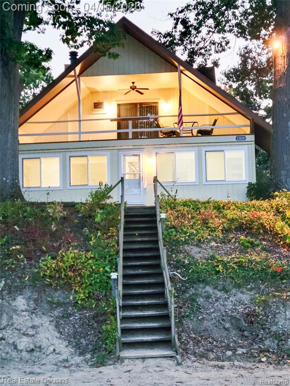 Enjoy your private lakefront lot including a dock. The spacious area makes the perfect setting for lakeside entertaining and relaxation.The cottage was renovated in 2025, including updated electrical, blending modern improvements with classic lake charm. A bright sunroom and entry area overlook the water and flow seamlessly into the open-concept living, dining, and kitchen areas—perfect for gatherings.The spacious kitchen includes a new stove and a refrigerator. Electric baseboard heat provides comfort on cooler days, or enjoy the natural wood-burning fireplace for added warmth and ambiance.Upstairs, the primary bedroom faces the lake and offers direct access to a private upper deck—an ideal place to relax and take in the views. The home features a full bath upstairs and a convenient half bath on the main level.Additional highlights include a rear deck for outdoor cooking and entertaining, plus two storage sheds for all your lake gear.Island property accessible by boat only—offering privacy, tranquility, and a true up-north feel right on Lake Fenton.  The sale of this property comes with 2 parcels.  13020 Fenton St parcel # 06-11-576-042 and lakefront parcel on Holly St parcel number 06-11-576-046.  Both parcels are larger than most Island lots and the waterfront parcel butts up to the lake.  This is the place where your own private dock is.  Once all property owners of the waterfront parcels are finished with new grading, you can plant grass seed and it will have a park like feel to it.