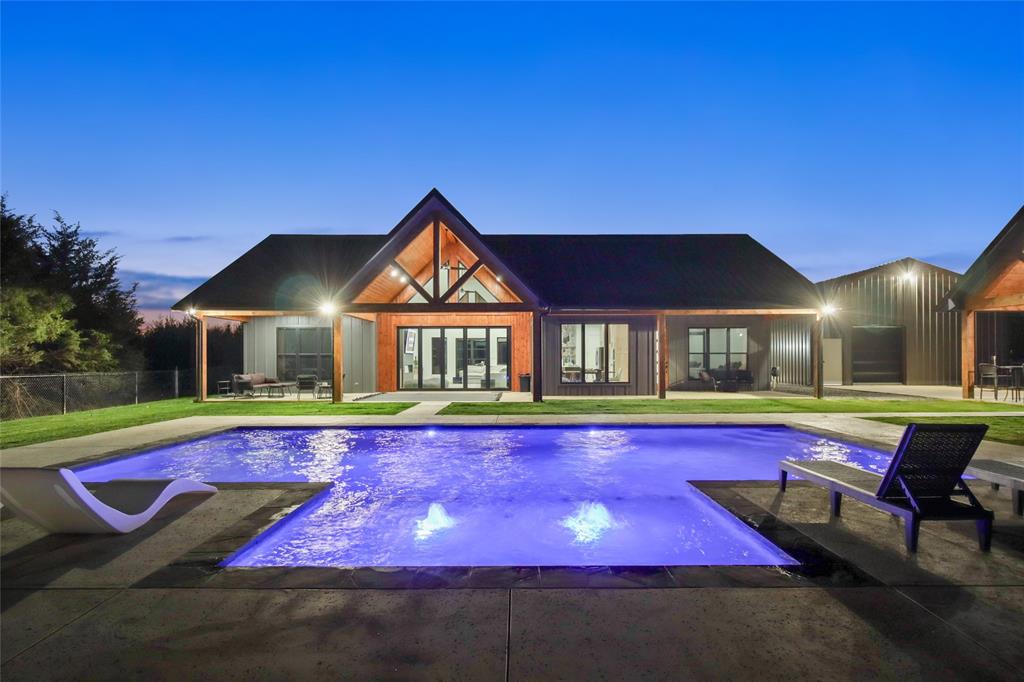 MOTIVATED SELLER! Discover superb craftsmanship with this 4 bedroom, 2.5 bath custom Barndominium on 12.51 acres with dazzling in-ground pool, cabana, workshop! A second residence at the front of the property is also available for purchase. Escape the hustle and bustle of city traffic while relaxing on this partly wooded spot that sits off a quiet County Road. Step inside this impressive vaulted entrance with 15-foot glass doors and find an abundance of light inside, with the many oversized picture windows. The dramatic living room comes with spectacular vaulted ceilings, an electric fireplace, and scenic views of the private backyard from a large covered back patio. Quartz countertops are included in the open kitchen that also has an island w-seating area, electric cooktop, built-in oven, premium cabinetry, and walk-in pantry. Panoramic views continue in the dining room full of custom windows. The lavish primary ensuite bedroom includes soaring vaulted ceilings, access to the backyard, double vanities, separate shower, soaking tub, and walk-in closet. Dip into the swanky in-ground pool with tanning ledge, Del Ozone system, and LED lights for added flair. Outdoor living is a breeze with a pool house, separate bathroom, outdoor kitchen grill, and lots of space for seating areas. A 30x30 workshop or garage with 220 wiring, front double doors, walk-thru door, and rollup door to backyard, connects to the main house by a walkway. AVAILABLE FOR PURCHASE: a completely-equipped separate 2nd residence--nicely designed 2024 manufactured home with over 1,000 sq.ft. for options as a rental, BnB, or guest space. You can find this phenomenal sanctuary only 15 minutes to the popular town of Sulphur Springs, 15 minutes from the world-renowned Lake Fork, and 78 minutes from downtown Dallas. Country living gets a fabulous upgrade with this upscale home built and owned by the original designer, and their plan became Barndominium Life's most popular plan. Ask about seller paid's.