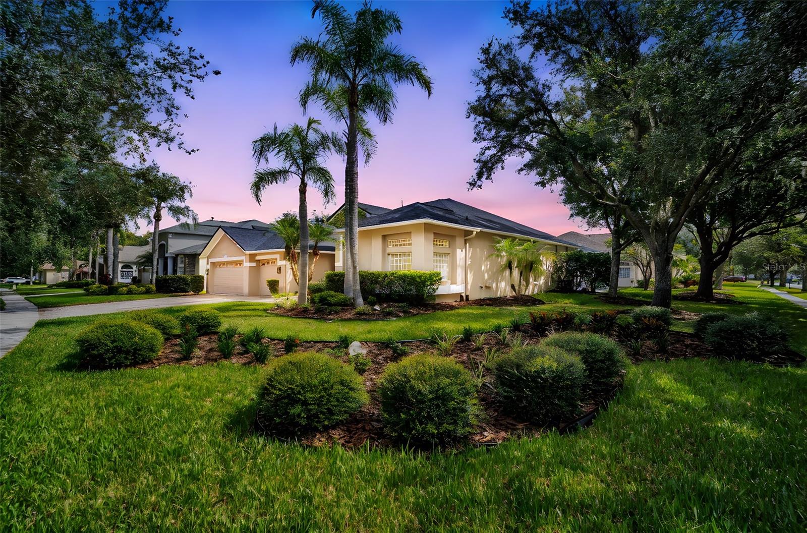 Welcome to 16315 Sambourne Ln, a completely remodeled corner-lot home in the gated community of Ashington Reserve at Tampa Palms North. Every detail has been upgraded, starting with a brand new roof installed August 2025, fresh exterior paint, sealed pavers, and lush landscaping. Inside you’ll find soaring 12-foot ceilings, newly installed Sand Dune porcelain tile throughout, creamy natural interior paint, and Lorraine Sienna luxury vinyl plank in the second third and fourth bedrooms. The chef’s kitchen showcases new natural oak-look soft-close cabinetry with antique bronze hardware, Bora Bora quartz countertops with a waterfall island, and stainless steel appliances including a custom ceiling-vented range hood. All three bathrooms have been tastefully remodeled, and the home’s centerpiece is an expansive, fully air-conditioned sunroom with walls of windows that open to the freshly turfed backyard complete with a putting green and drainage tiles—perfect for entertaining or relaxing in style. A three-car garage with newly epoxied floors, plus a new 2.5-ton HVAC unit, add comfort and convenience. Residents of Ashington Reserve enjoy access to Club Tampa Palms with resort-style pool, fitness center, tennis and basketball courts, playgrounds, and more—with no CDD fees. This move-in-ready property has been meticulously renovated with every square inch upgraded to the highest standard.