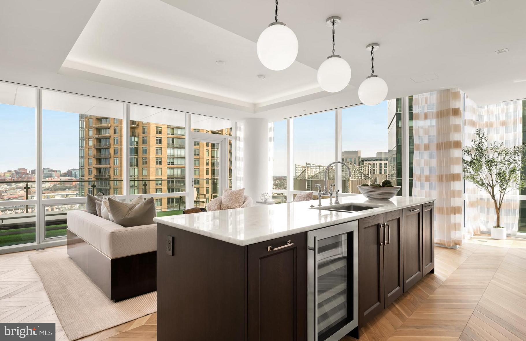 BRAND NEW ONE-BEDROOM CORNER UNIT WITH BALCONY AVAILABLE!Welcome to the Four Seasons Private Residences in Harbor East, where luxury meets lifestyle in Baltimore’s most coveted waterfront address. This stunning one-bedroom, one-and-a-half-bathroom corner unit w/ balcony was thoughtfully designed to utilize every inch with purpose, so it lives larger than 1,222 sq ft! Step into an atmosphere of sophistication with soaring ceilings, rich walnut chevron-patterned flooring, and designer finishes throughout. Expansive floor-to-ceiling windows bathe the home with natural light while showcasing views of the city skyline and Inner Harbor. The gourmet kitchen is a chef’s dream, outfitted with Miele appliances, sleek Eggersmann soft-close cabinetry, luxurious marble stone countertops, and a built-in Sub-Zero wine fridge - perfectly blending timeless elegance with modern function. The primary suite is a tranquil sanctuary, offering a custom-built walk-in closet for optimal storage and a spa-inspired, marble-clad en-suite bath featuring a double vanity with designer finishes, and a glass-enclosed walk-in shower with a built-in bench and niche, inviting total relaxation. A spacious powder room provides added comfort and privacy for guests, and the home is enhanced throughout by motorized window shades and thoughtfully selected lighting.The Four Seasons Private Residences Baltimore offers a turn-key elevated lifestyle. As a resident, you'll enjoy a private entrance where you will be met by our full service concierge and on-site building manager to assist with your every need, as well as exclusive access to the sprawling 28th-floor amenity level, where world-class services meet resort-style indulgence. Amenities include an indoor heated saltwater infinity-edge pool, state-of-the-art fitness center, sauna, coffee station, billiard room, and numerous elegant gathering spaces. Multiple rooftop decks offer panoramic city and harbor views, complete with indoor and outdoor fireplaces, a grilling station, a dining area, and a kitchen, all ideal for entertaining. Completing this unparalleled lifestyle experience are a fully equipped conference room and a dedicated AstroTurf dog-walking area. This residence offers the rare opportunity to live within a full-service, hotel-branded building while enjoying the privacy and sophistication of a true luxury home. All set within steps of Harbor East’s acclaimed restaurants, shopping, and the waterfront promenade. This is a MUST SEE ONE BEDROOM!! Immediate occupancy is available. Come see what all the fuss is about! *Photos are from our sales office which is a model of the same exact floor plan*