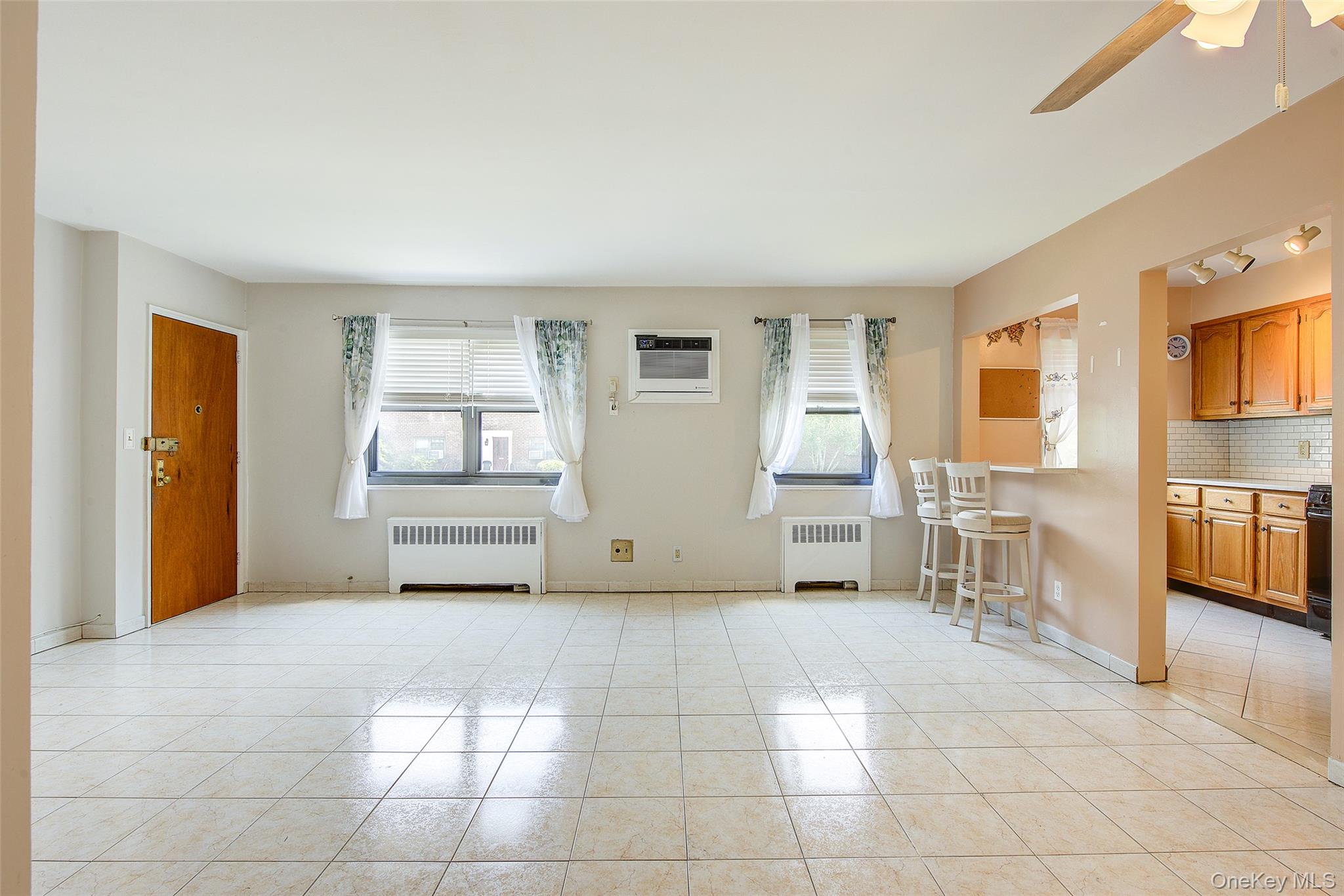 Renovated two-bedroom, one bath unit in the co-op community of Clearview Gardens. This spacious apartment has been recently renovated with tile floors and wood laminate in the bedrooms.  It has an updated kitchen, with light wood cabinets, quartz countertops, a tile backsplash and a pass-through breakfast bar.  The kitchen also includes an over-range microwave, a dishwasher and a stacked washer and dryer for convenience.  Both bedrooms are generously sized with lots of closet space and there are a total of 5 closets in the unit.  The windowed bathroom has floor-to-ceiling tiles and a full bathtub/shower. All doors in the unit are solid wood for a more elegant feel and the window treatments are included, as well as the 2 wall AC units and overhead ceiling fans.  This home is close to schools, shopping, restaurants and parks.  For transportation, highway access and 2 bridges are very nearby. The stop for the QM20 Express Bus to Manhattan is 2 blocks away and the Q76, (College Point to Jamaica) and Q61, (Beechhurst to Flushing) are only 1 block away.
