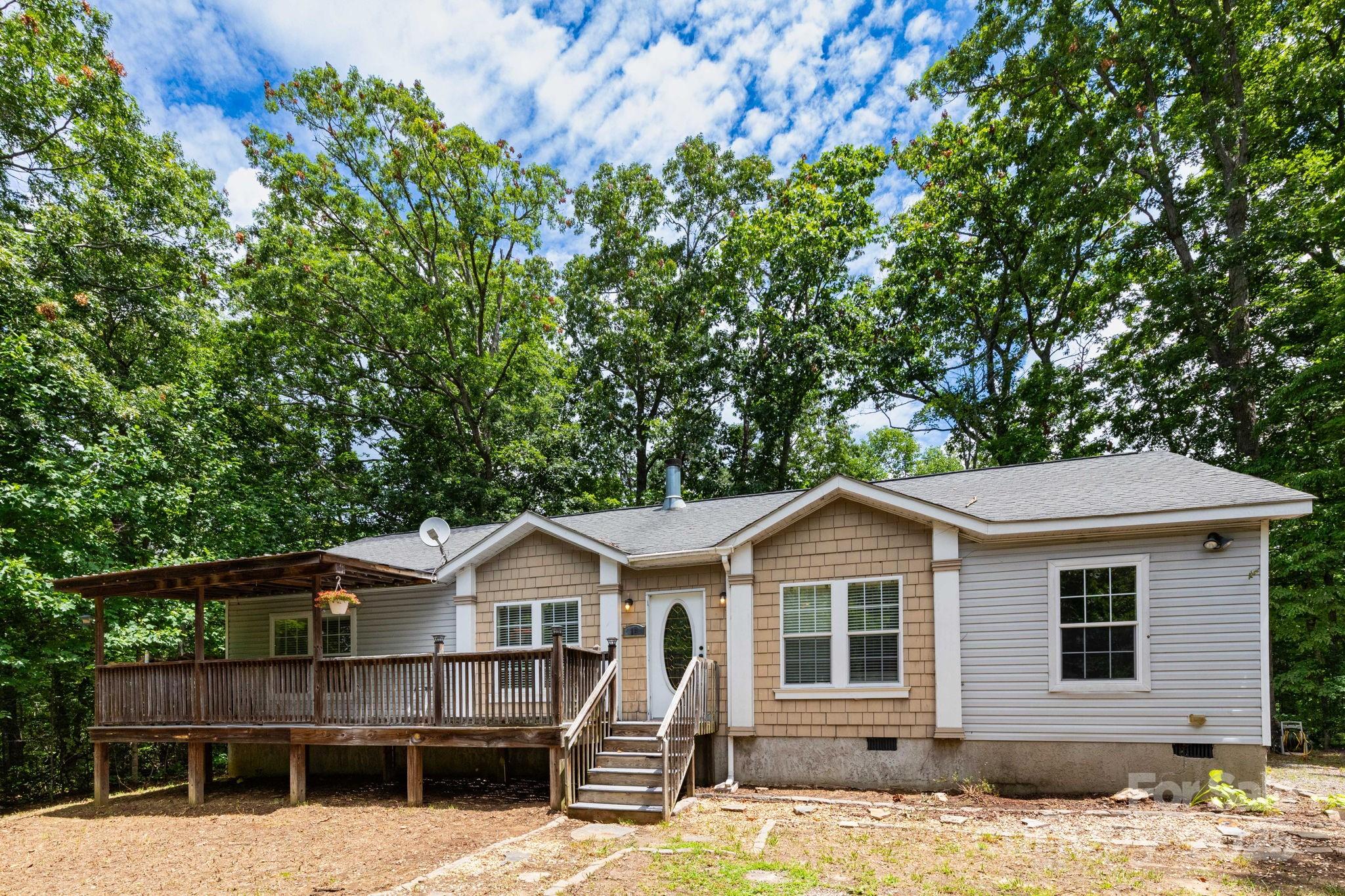 Whether you’re a first-time buyer or an investor looking for a solid opportunity, this 3-bedroom, 2-bath home in Fairview checks all the boxes. Just 20 minutes from downtown Asheville, it sits on a full acre with mountain views, one-level living, a spacious open floor plan, cozy fireplace, and a covered front porch. This gem has been freshly painted and has new luxury vinyl planking throughout. With a little vision and personal touch, this property has great potential as a primary residence, long-term rental, or even a vacation getaway. Don’t miss out on this versatile find in a peaceful mountain setting!