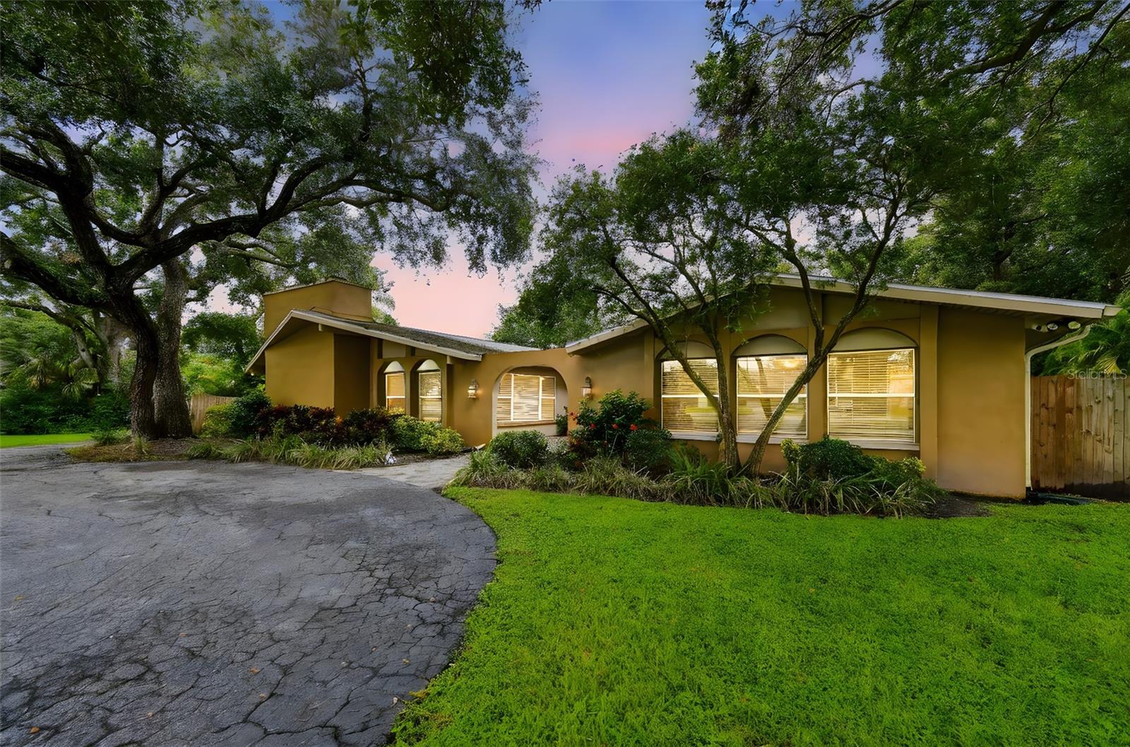 Introducing a remarkable luxury estate in the prestigious Belleair Road location, situated on an expansive ¾ acre lot. This exquisite Clearwater home offers an elegant yet witty charm, making it an exceptional choice for both family living and investment opportunities. Step inside to discover over 4,651 square feet of well-appointed living space featuring five spacious bedrooms and four and a half bathrooms. Two magnificent master suites provide peaceful retreats, while a generous in-law suite with a private balcony and separate entrance adds versatile living options. The open floor plan invites effortless entertaining, seamlessly connecting indoor and outdoor spaces. The remodeled saltwater pool, complete with a screened enclosure and PebbleTech finish, serves as the centerpiece of this outdoor oasis. The newly re-screened pool cage allows for uninterrupted enjoyment of the Florida sunshine. Relish in the pool views from the comfort of your private outdoor space, or take a refreshing dip in your private pool. Designed for both relaxation and recreation, this estate includes a dedicated arcade/game room and ample parking for all your vehicles and recreational toys—thanks to the 2-car garage, 3-car carport, and additional parking for jet skis or motorcycles. Modern smart technology complements the home’s luxury, with Honeywell thermostats, smart locks, Arlo security cameras, and a smart garage system ensuring both convenience and security. Recent upgrades highlight the home's impeccable maintenance, including a new roof (2020), HVAC updated with smart thermostats (2022), new water heater (2021), and freshly installed gutters and front fence (2025). The estate boasts a strong Airbnb income history with over $285k in gross bookings over the past three years, showcasing its investment potential. Previously owned by world champion boxer Keith Thurman Jr., this property offers a unique blend of prestige, comfort, and modern sophistication. Just minutes away from Clearwater Beach, Belleair Beach, and vibrant downtown areas, this highly desirable neighborhood offers no rental restrictions, ensuring both freedom and flexibility. Embrace luxury living in one of Tampa Bay’s most sought-after neighborhoods, where elegance meets opportunity. Welcome home to your prestigious Belleair Road estate.