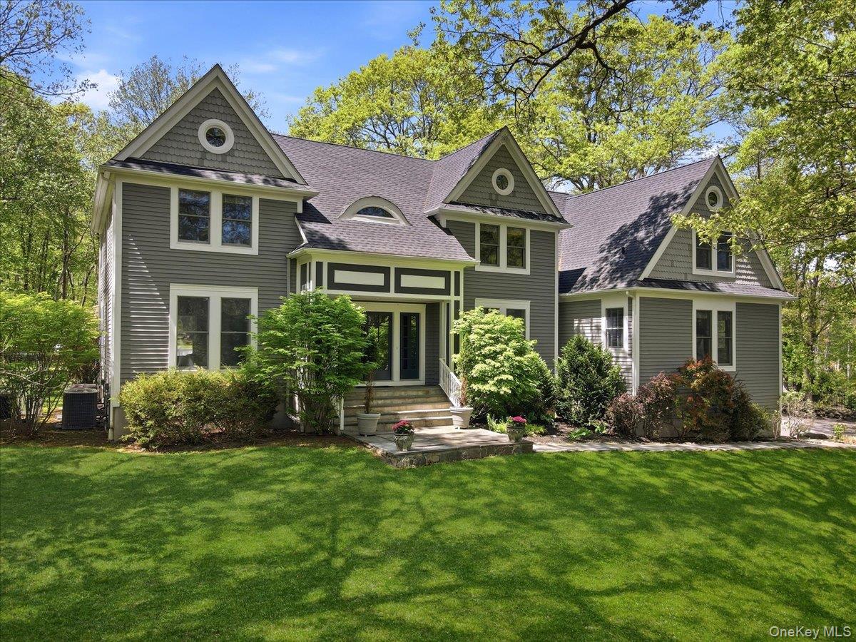 Beautifully set on 2.29 private acres, this updated Colonial blends classic design with modern comfort, offering expansive living spaces and a highly functional layout. A stone-pillar entrance leads to a meticulously maintained home featuring a dramatic two-story foyer, formal living and dining rooms, and an updated chef’s kitchen with refinished cabinetry, professional-grade stainless steel appliances, and a Brazilian cherry center island. The kitchen opens to a sun-filled breakfast area and a vaulted family room with a fireplace and French doors. Enjoy seamless indoor-outdoor living with a newly refinished deck overlooking the private, park-like setting, plus a bright four-season sunroom for year-round use. The first floor includes a private in-law/guest suite with a separate living area, gas fireplace, bedroom, full bath, and its own laundry—ideal for extended family, au pair, or home office. Upstairs features a spacious primary suite, three additional bedrooms, a full bath, and second-floor laundry. Extensive recent updates include: freshly painted interior and exterior spaces (2025), siding and trim improvements (2025), two new AC compressors (2025), refinished hardwood floors, updated kitchen finishes, and a newer roof (2020). Additional highlights include a whole-house generator, water softener and pH system, heated garage, new sod, bluestone walkway, custom fire pit area, and outdoor lighting. Private yet convenient to town, shopping, schools, and commuting routes—move-in ready with significant upgrades throughout.