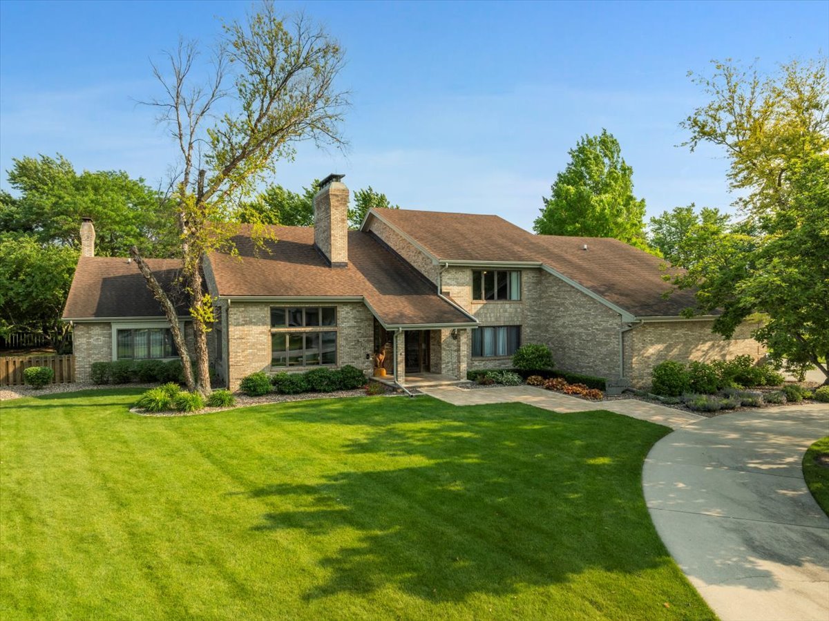 Amazing home located on the 15th fairway on the Oaks at River's Edge golf course in Fairway View subdivision in Pontiac! This all brick home has a steel infrastructure, allowing for large open concepts. Start your journey into this home by walking up the brick lined heated walkway and enter the beautiful tall double doors to the most breathtaking foyer with a two story double sided fireplace and winding stairway leading upstairs. Entertaining your family and friends has endless possibilities with this home! The gourmet kitchen was remodeled in 2019 with custom cabinets topped with quartz countertops. Utilize the dry bar area with wine fridge, and then gather and converse around the multiple islands. Sit in the dining area and enjoy company under the coffered ceilings or relax and enjoy the beautiful sunroom that spans the entire kitchen and dining room with multiple exits to plenty of outdoor entertaining areas.  The extra large family room has plenty of space to accommodate large gatherings. The Primary bedroom has a walk up loft as well as it's own private sunroom and 5 separate closets. Primary bath was completely remodeled in 2019 with large walk in tiled shower with multiple showerheads, a whirlpool tub, and laundry room. All 4 bedrooms have in suite bathrooms! Large office currently being used as another family room could be used as a 5th bedroom if needed. Multiple balconies upstairs offer great views of the course. This massive 3 car garage not only has new exterior doors, but the real car lover's dream is what is found inside. A Moral Car Lift was installed which opens to the basement and allows multiple cars to be parked in the basement for storage and mild mechanical work! Also located in the basement is a 16 seat theater room with a 180" 4K high definition projector and screen wired for 9.1 Surround Sound. The home is equipped with an amazing Crestron CP4-R technology system. With multiple smart touch panels and touch screen remotes, you can access and control any video pathing, lighting, doors, fans, fireplaces, Sonos sound system, intercom, and video surveillance from multiple rooms in the house! The entire system can also be accessed remotely from your smartphone. Enjoy some sun and the views of the course on the Unlock patio or relax in the shade under the screened in gazebo.  New skylights installed with shades, shades and windows open and are controlled by a remote. Seller has done so many updates since purchase, this home must be seen in person to appreciate all it has to offer! NEW Water Heater August 2025
