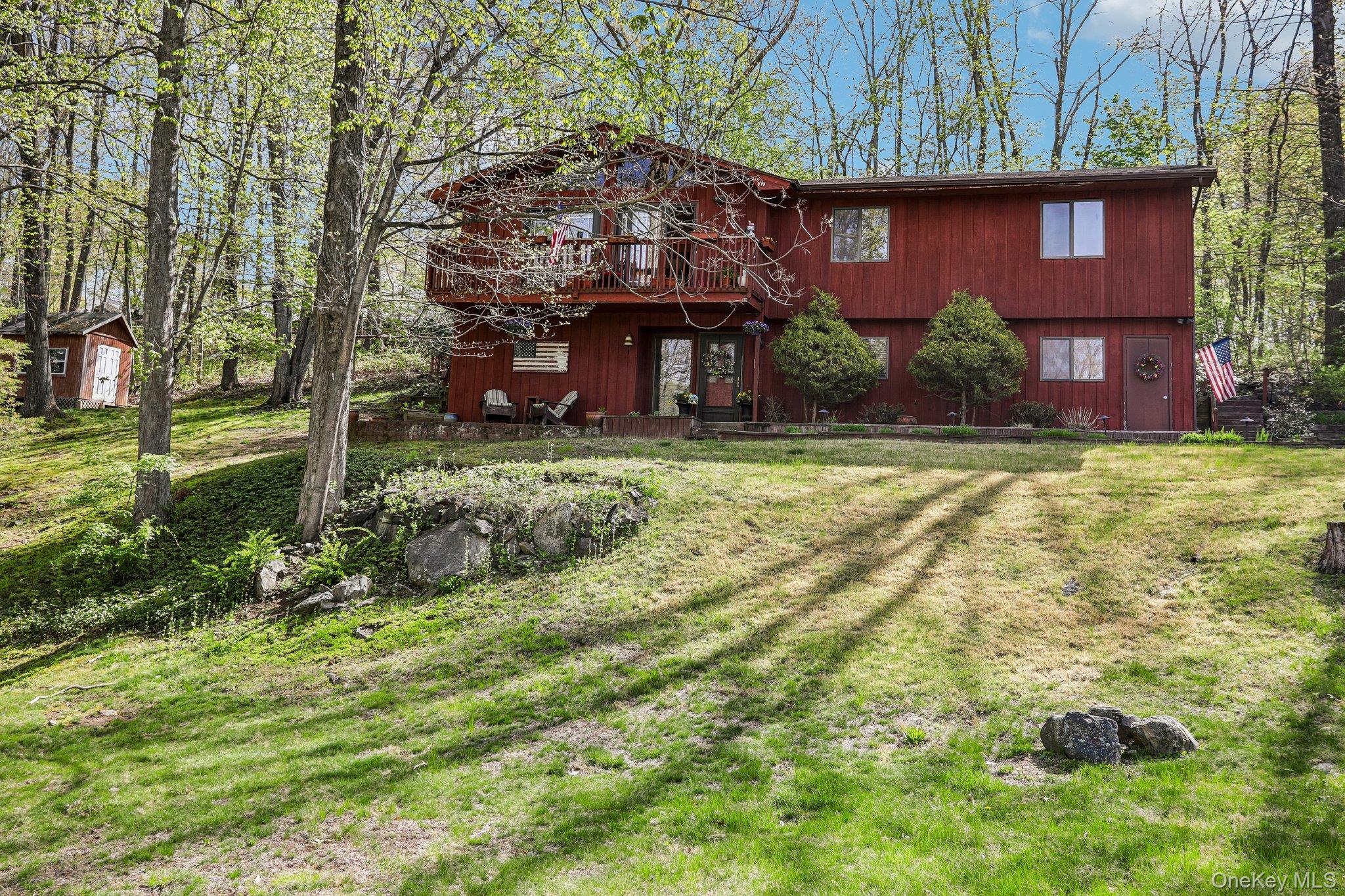 This is a 3-bedroom, 2.5-bath home in the peaceful town of Somers, offering comfort, space, and convenience. Step inside through the front foyer and into the first-level living room, featuring a cozy wood-burning fireplace. This level also includes a half bathroom, laundry room, and access to the attached two-car garage. Upstairs, the sun-filled main living room is filled with natural light from oversized windows and sliding glass doors, creating a warm and inviting space for everyday living or entertaining. Just off the living room is the formal dining room, which connects to the separate kitchen and offers direct access to the spacious deck—perfect for summer barbecues and outdoor gatherings. Down the hall, you’ll find two well-sized bedrooms, each with its own closet, a full hall bathroom, and the primary bedroom with an en suite bath. Ideally located just minutes from I-684, the Croton Falls and Purdy's train stations, this home offers a peaceful setting with an easy commute.