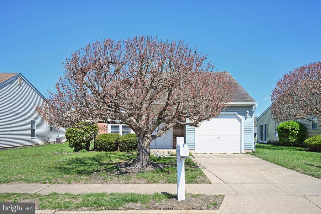 Enjoy the ease of simple living in this pristine, move-in ready home in desirable Holiday Village. A welcoming foyer with newer wood-look laminate flooring and freshly painted neutral walls sets the tone for the home. The laminate flooring continues into the kitchen, where oak cabinetry provides abundant cabinet and counter space. A boxed bay window fills the kitchen with natural light, while the stainless smooth-top range offers both style and easy maintenance. There is also space for a small table and chairs, perfect for casual meals.The formal dining room is generously sized and can easily accommodate a large table and serving pieces. Open to the dining room, the spacious living room creates an ideal layout for everyday living and entertaining. Fresh newer carpeting extends throughout the remainder of the home, adding warmth and comfort.A bright and inviting sunroom offers additional living space and is filled with natural light from surrounding windows and sliding glass doors. The primary suite overlooks the backyard and is large enough for a king-size bed and oversized furniture. The bedroom features fresh neutral carpeting, a dressing area with vanity sink, a walk-in closet, and a private bath with laminate flooring and a stall shower.The second bedroom is also generously sized and neutrally decorated. The hall bath has been updated with newer white cabinetry, silver hardware, and a marble-look vanity top. A convenient laundry room includes plenty of shelving for extra storage.Enjoy the carefree lifestyle Holiday Village is known for, including a clubhouse, swimming pool, and an array of planned activities and amenities. This sparkling home has been lovingly maintained and is ready for its next owners. Some of the windows have been replaced.  The remaining windows and doors are being conveyed in AS IS condition.