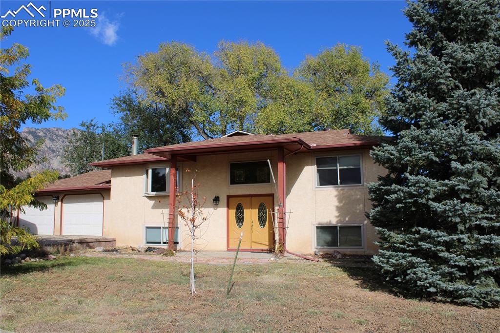 Don't miss this great escape from the city!  You're in the country, but 10 minutes to town and basically across the road from Ft. Carson Gate 5.  Sit on your back deck and enjoy the wildlife while taking in the fantastic views of Cheyenne Mountain.  The hot tub stays with property and is only about 3 years old.  This 3-bed, 2-bath home is unique in that the heating is in the ceiling and each room has its own thermostat.  No propane for this property.  The primary bedroom has beautiful wood floors, built-ins, a nice sized walk-in closet and room for a small sitting area.  The spacious family room on the lower level is perfect for gatherings with its wood burning fireplace.  The kitchen will please you with beautiful granite countertops, a counter for people to sit and converse while you're cooking, soft close cabinetry and stainless appliances.  There is pleny of space for RV parking, trailer parking or equipment storing along with the 2-car garage and additional carport.  Evening walks are popular and stargazing is a must!  Please come take a look and see for yourself.