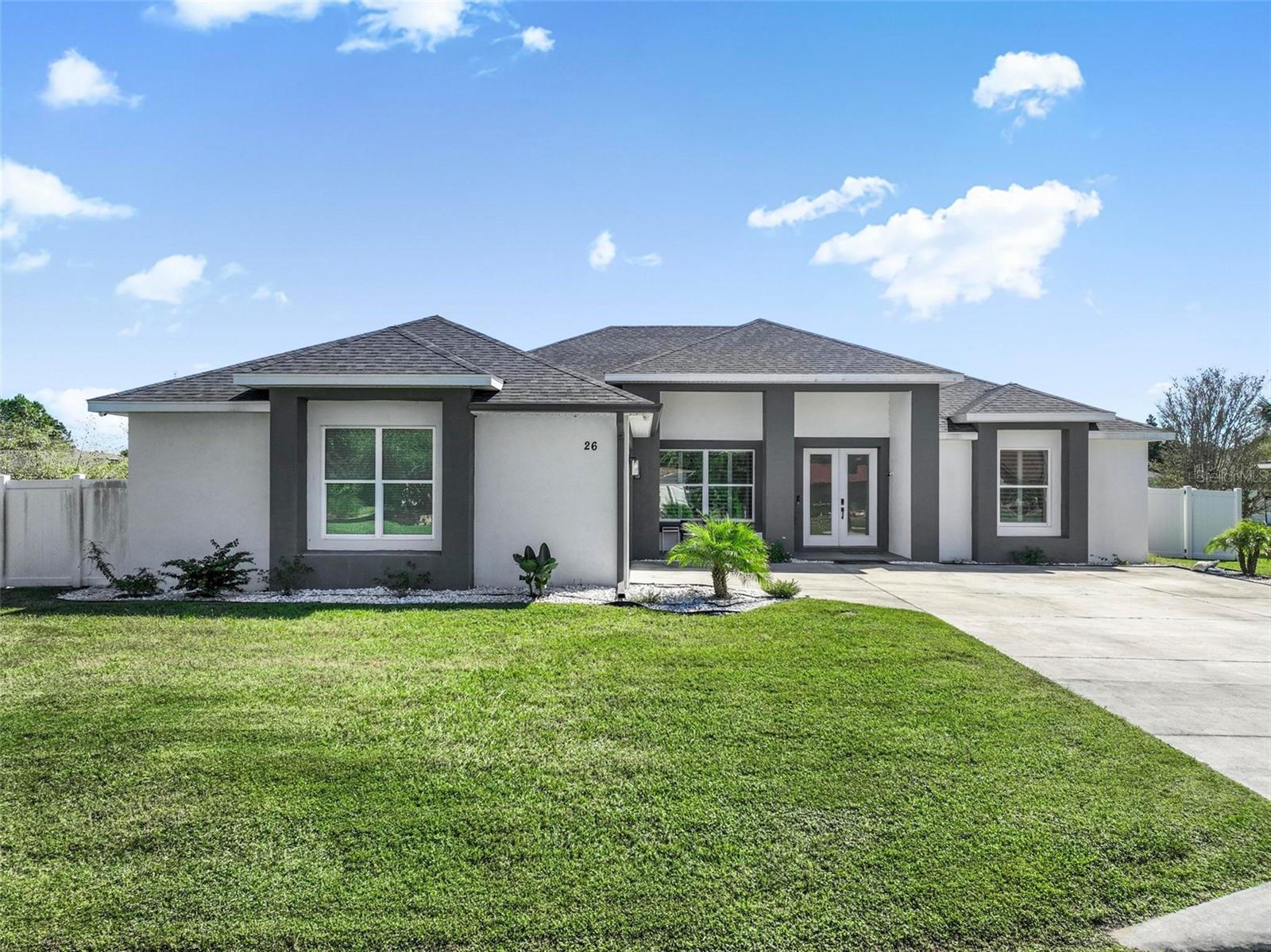 Experience contemporary luxury in this custom-built 2021 concrete block residence, offering 2,509 sq. ft. of thoughtfully designed living space, 3 bedrooms, 3 full baths, and an oversized 2-car garage. The open-concept design centers around a beautifully appointed chef’s kitchen featuring premium appliances, including a GE Café refrigerator, ASKO dishwasher, XO built-in beverage cooler, and ZLine induction cooktop. A generous deep-basin sink, Moen extension faucet, and dedicated coffee bar create an elegant space for everyday living and entertaining. The expansive primary ensuite offers a private retreat with a jetted soaking tub, multiflow shower, dual undermount sinks, and a private water closet. Elevated comfort and convenience continue with a Kinetico whole-house water-softening system, reverse-osmosis drinking water with advanced filtration, Moen smart leak detection, and built-in surround sound in the living area.  The oversized garage features built-in cabinetry, a dedicated workshop, and smart remote entry. Outdoors, a fully enclosed 6-foot vinyl privacy fence with two side gates provides a private, functional setting. Combining solid concrete block construction, sophisticated contemporary design, premium kitchen amenities, and advanced home systems, this distinctive residence delivers modern luxury with exceptional attention to detail.