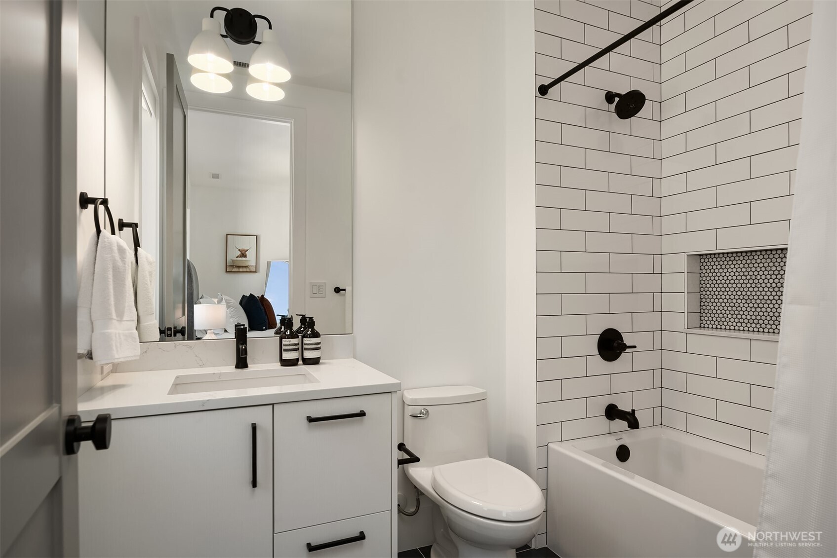 Bathroom with subway-tiled tub and shower