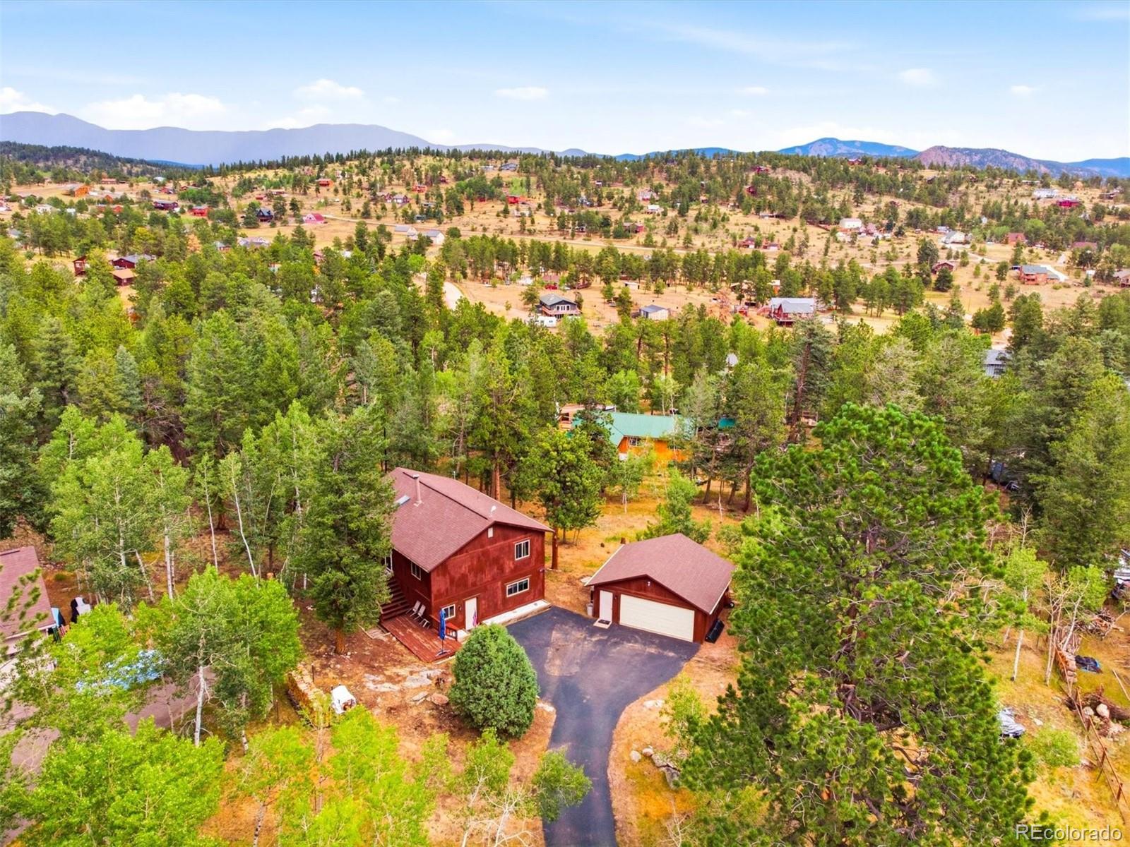 Nestled at the end of a cul de sac, this solidly built Mountain Raised Ranch offers over 2100 sq ft of comfortable living space On 1.3  gently sloping, usable acres. The home features 3 bedrooms and 2 baths including a  private lower level Master suite with enormous walk in shower, separate laundry room and dressing area.Enjoy the outdoors from the expansive decking perfect for relaxing or entertaining while taking in the peaceful mountain setting.Inside you are invited to the open great room with bay window plus updated kitchen, dining area  tongue and groove wood ceiling and skylights .. two wood stoves one on each level add warmth and rustic charm, complemented by electric heat controlled in each room, for year round comfort.This property also includes a detatched two car garage with built in workbench, making it ideal for projects, hobbies, or extra storage.Conveniently located approx 50 minutes from Denver, this property and home offers the perfect balance of mountain tranquility and city accessibility.  Come see and make it your Home.  New septic tank installed 8/26.  New kitchen nd bathroom flooring Newer roof