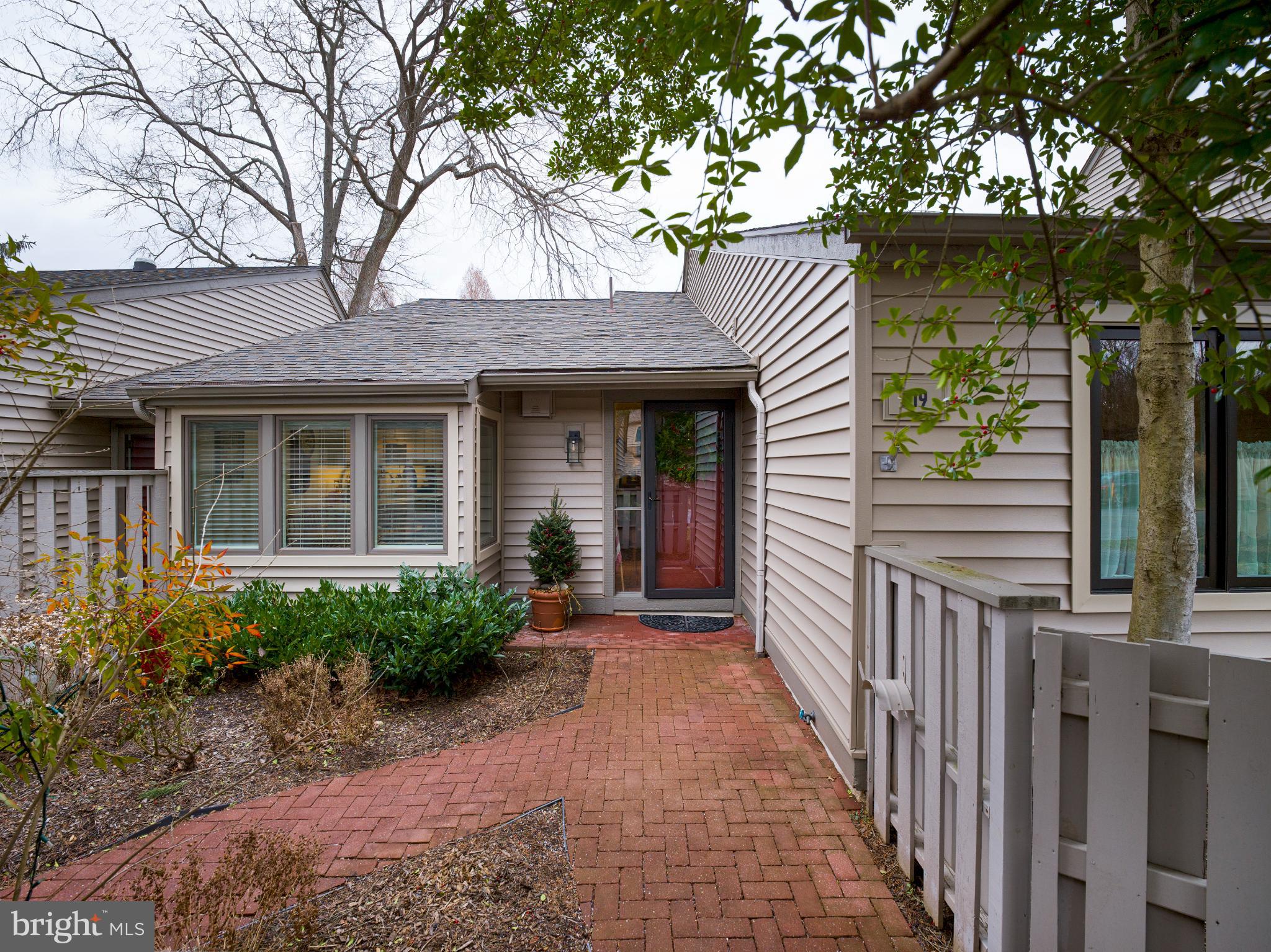 Welcome to effortless living in the highly sought-after Chatham Village of Hershey’s Mill, a premier 55+ community known for its exceptional amenities and picturesque golf course setting. This fully renovated, completely move-in-ready 3-bedroom, 2-bath home with a 1-car garage is ideally situated on a quiet cul-de-sac with sweeping views of the 16th hole and ample guest parking nearby.A beautifully landscaped, fenced front courtyard creates a warm and welcoming approach. Inside, an open foyer showcases gleaming hardwood floors that extend throughout the home. To the right, the thoughtfully renovated kitchen has been opened up to enhance flow and functionality, featuring tiled floors, a center island, updated cabinetry, quartz countertops, stainless steel appliances, and a charming eat-in area set within a box bay window overlooking the courtyard.The kitchen opens seamlessly into a nicely sized dining room with space for a full dining table, golf course views, and a new sliding glass door leading to the rear patio—perfect for indoor-outdoor entertaining. Beyond the dining room, the spacious living room offers built-in bookcases and a wood-burning fireplace, creating a comfortable and inviting gathering space.The primary suite is generously sized and filled with natural light, offering two large closets and a new sliding glass door that opens to a second private patio with golf course views. An outdoor storage closet is conveniently located just off this patio. The renovated primary bathroom features a double vanity with ample storage, a walk-in shower, and heated floors for year-round comfort.Down the hall, a bright guest bedroom with large windows is serviced by an updated hall bath. The third bedroom is currently used as a den, providing a cozy secondary living space ideal for relaxing, reading, or hosting guests. Completing the home are a dedicated laundry room and two large storage closets, offering excellent functionality and storage.Recent community capital improvements include new windows, new siding, exterior painting, and new sliding glass doors, adding peace of mind and long-term value.Residents of Hershey’s Mill enjoy 24/7 security, community gathering spaces, scenic walking trails, tennis courts, a pool, and a championship golf course with optional membership. This is refined, low-maintenance living in one of the community’s most desirable villages—beautifully updated, perfectly located, and truly move-in ready.