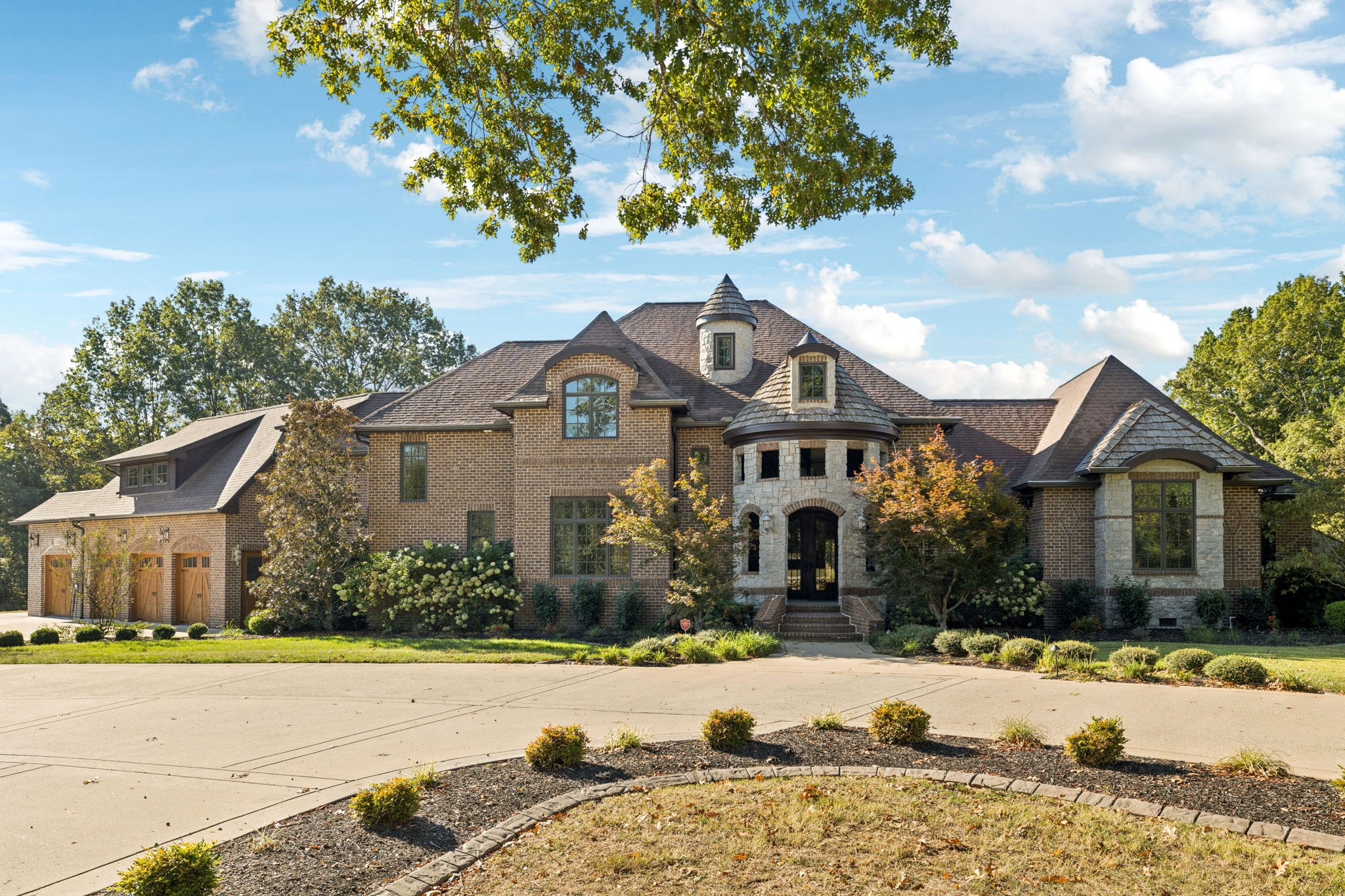 Great family compound and private retreat with many custom upgrades and finishes. New Shingle roof installed in April. This would be a perfect fit for a Nashville entertainer looking for privacy. Two beautiful homes and a shop building, 6.67 acres of private acreage, convenient to Mt. Juliet and Nashville.  The striking main residence includes 5,684 sq ft, built in 2010. Main House- 4 bedrooms, 4 full baths and 2 half baths, expansive living area with fireplace open to a large chef's kitchen, formal dining room, primary bedroom with on suite bath and walk in closet. A large home office or den area is on the main level, along with a work out room with infrared sauna and adjacent full bath.  Secured safe room, whole home generator.  Right outside the living area doors offers a family oasis with large in ground swimming pool, motorized screened in porch, full outdoor kitchen with built in grill.  The upstairs expansion includes another master suite and underneath is the 4 car oversized garage.  The guest house is perfect for family, guests, or musicians retreat/studio with 1,556 sq ft, fully renovated in 2021, offers two bedrooms, one bathroom, full kitchen and den area, with a full wrap around porch.  1,500 sq ft finished barn (built in 2022), which could be used as a separate office, man cave or game room, which has central heat & air.   This private family compound retreat is the perfect, convenient spot to gather, experience and live in a natural private setting with nature and wildlife.