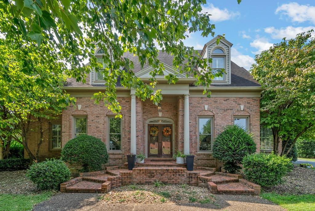 Stunning all-brick 5 bedroom, 3.5 bath home featuring a spacious bonus room with dual entries—one from inside the home and one from the garage. The open living room boasts soaring 23-ft ceilings, a cozy fireplace, and glass French sliding doors leading to the backyard. The large kitchen offers custom cabinetry, granite countertops, and plenty of workspace. Additional highlights include a workout room with washer & dryer hookups, a 9'5" x 16'8" screened porch, and abundant storage throughout. Outdoors, enjoy an in-ground saltwater pool with new pump, expansive patio space, and a pool house with half bath—perfect for entertaining. Home is equipped with 2 gas water heaters and 3 HVAC systems for comfort and efficiency. Large backyard completes this exceptional property!