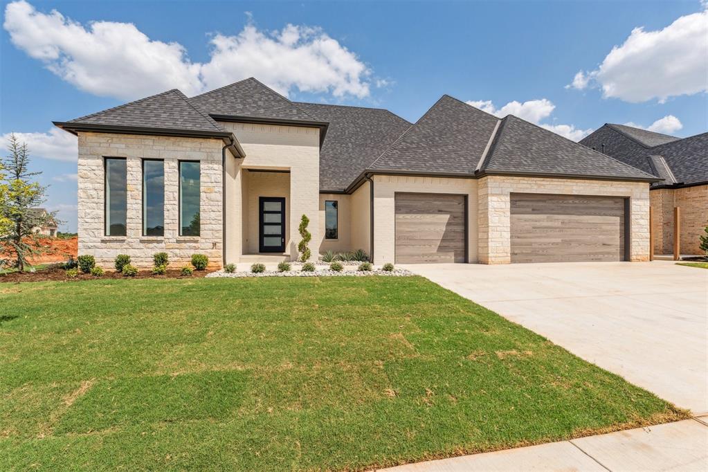 Located in one of Edmond’s premier gated communities, this stunning new construction home is nestled in the newest section of Fallbrook, offering residents exclusive access to a scenic walking trail, large pool, clubhouse, and sports courts. This thoughtfully designed, single-level home features 4 spacious bedrooms, 3.5 baths, a private study, and a versatile game room—all under soaring 12-foot ceilings that create an open and airy feel throughout. The exterior showcases a striking blend of painted brick and stone, for a timeless yet modern design. Step through the oversized front entry and into a living space where quality and elegance meet. The gourmet kitchen is a showpiece with an oversized island, custom cabinetry with stained wood accents, quartz and granite countertops, GE appliances, and a large walk-in pantry with additional counter space—perfect for prep and storage. On one side of the home, two bedrooms share a generous Jack-and-Jill bath, each with its own vanity and walk-in closet along with a game room/flexroom complete with a dryer. On the other end, the private primary suite offers a true retreat, complete with hardwood floors. The spa-like primary bath boasts custom cabinetry with built-in pullouts, a stunning curbless shower with frameless glass, and designer finishes throughout.A guest bedroom with en-suite bath sits at the front of the home next to the dedicated study—perfect for remote work or quiet reading. Practicality hasn’t been overlooked—the utility room includes a sink and abundant storage, while the TRUE 3-car garage provides ample room for vehicles and gear. Additional upgrades include TREX fencing, full guttering, and concrete walkways along both sides of the home. This home truly has it all—come see it for yourself and experience the Fallbrook lifestyle!