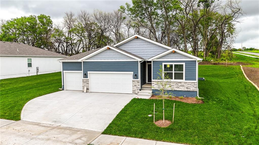 Pack your things and get moving because this one is ready to go!  Welcome to this stunning 3 bedroom, 3 bathroom home with a spacious 3-car garage on a home site backing to greenspace and privacy! The open-concept living area is flooded with natural light from large picture windows framing a beautiful yard and treed view.  Featuring a modern kitchen (with large walk-in pantry) perfect for both everyday living and entertaining, this home also enjoys a private primary retreat, complete with an en-suite bathroom and ample closet space that is also connected to the laundry room.  The secondary bedroom on the main level would make a perfect home office or a guest suite while the third private bedroom in the finished lower level sits next to another full bath and a large rec room just waiting for your use and decor ideas to come to life.  But it doesn't end there.  You still have 700 square feet of unfinished space for storage or future expansion potential!  Eastbrooke at Creekmoor has it all!  Designed around 108 acre Lake Creekmoor and the acclaimed 18 Hole Championship Golf Course, Creekmoor offers one of the most comprehensive residential amenities packages available, where homeowners with both active and relaxed lifestyles enjoy what feels like vacation all year long.  Pools, tennis, pickleball, basketball, 24-hour fitness center, golf pro shop, Tavern on the Moor restaurant and bar, fishing, boating, SUP, and still more...it's ALL here!  With an abundance of shops, restaurants and services minutes away and with easy access to Jackson and Johnson Counties, homeowners have all the benefits of metro living at their fingertips while enjoying home life outside the hustle and bustle. Whether making your first home purchase or your last, this is a destination community like no other.