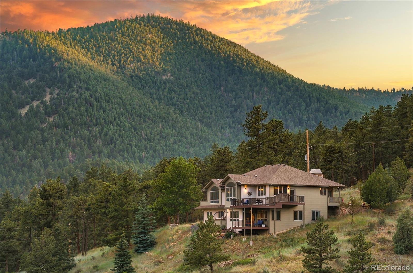Where luxury, privacy, and breathtaking mountain scenery come together, this extraordinary Mountain Modern home offers an unmatched foothills lifestyle just minutes from Boulder. Perfectly positioned on 1.5 private acres with sweeping mountain views, this exceptional 4-bedroom, 3.5-bath residence offers a beautifully redesigned living space. Completely renovated, the home seamlessly blends sophisticated design with modern comfort. The chef's kitchen is a true showpiece featuring waterfall granite countertops, premium Thermador appliances, wine refrigerator, reverse osmosis water system, and WiFi-enabled smart appliances. The luxurious primary suite is a private spa retreat with its own fireplace, heated bathroom floors, custom-built walk-in closet, and an extraordinary steam shower with dual shower stations, overhead rain shower, aromatherapy, music, and light therapy. An amazing Mother-In-Law Suite rounds out the lower level with a Kitchenette, Livng Room, Dining area, Office, En-Suite Bed/Bath, and Outdoor Space. Designed for today's connected lifestyle, the home includes Starlink internet, whole-home smart lighting compatible with Alexa and Google Home, central vacuum, WiFi-enabled smoke detectors, a WiFi garage door opener with battery backup, and a new electrical panel. Extensive outdoor living includes multiple decks and a beautiful patio. Additional upgrades include radiant in-floor heat on the lower level, forced-air heat and central air upstairs, a new well pump, water softener, a Class 4 impact-resistant roof, freshly painted exterior, irrigation setup, and county-maintained roads with snow removal. Surrounded by abundant wildlife and unforgettable mountain vistas, this remarkable property offers peaceful Colorado mountain living with quick access to downtown Boulder, world-class hiking and biking trails, dining, shopping, and more. Every finish has been thoughtfully selected to create a home that is both timeless and inviting.