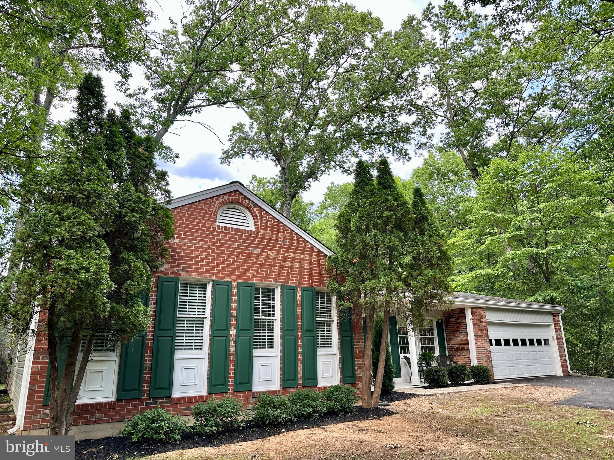 Professional photos June 2nd. Welcome to 2520 Penny Royal Ln, a charming rambler well-loved by the original owner, nestled on a .67 acre corner lot surrounded by trees and all the nature and beauty Reston has to offer.  The kitchen is the heart of the home with high ceilings, a lovely skylight, updated 42" cabinetry, granite countertops, stainless steel appliances and a breakfast area seated in front of a picture perfect window. Bright and open, the living room boasts pretty molding and flows seamlessly into the formal dining with beautiful hardwood flooring. A cozy family room with a brick mantled, wood burning fireplace leads out a sliding glass door to a spacious outdoor patio, as well as access to the 2-car garage. Four comfortable bedrooms and 2 full baths complete this level. The recreation room provides a 3rd living area in addition to a large storage room. Brand new driveway, brand new attic insulation, freshly powerwashed, painted and ready for its new owners. Conveniently located to 3 shopping centers and only minutes to the Wiehle metro and the restaurants at Reston Station. Enjoy Reston's 55 miles of trails + the W&OD, 15 pools, tennis and pickleball courts, 4 lakes, and the countless shops, restaurants, festivals and concerts at the Reston Town Center as well as Lake Anne's Saturday morning farmer's market. Live, Work & Play Reston!