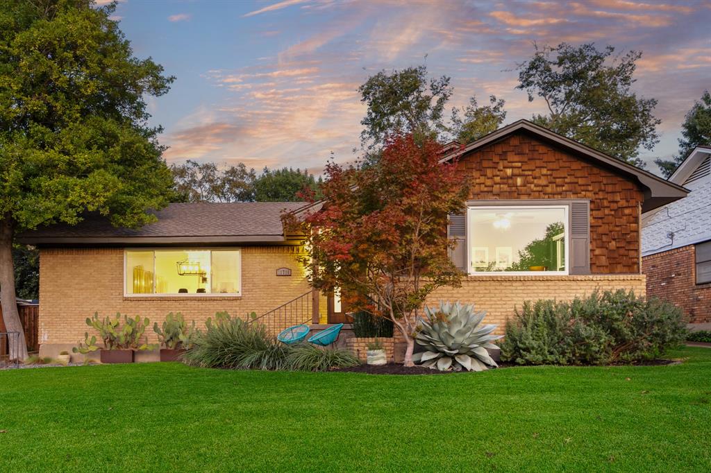 Nestled on a quiet, elevated lot in the heart of Lochwood, this home offers a blend of modern design and comfort with thoughtful use of space. Natural light fills the open living and dining areas, where clean lines and refined finishes create an inviting, contemporary atmosphere. The kitchen is both stylish and functional, featuring custom cabinetry, a striking tile backsplash, quartz countertops, and stainless steel appliances. The primary suite feels like a private retreat, complete with a navy accent wall, custom wood-slat sliding doors, and an en suite bath with a marble-tiled shower, quartzite countertops, and brass fixtures. A generous secondary living area centers around a limestone-hearth fireplace, offering flexible space for a media room, playroom, or home office. Outside, the backyard oasis extends the living space even further. The butterfly-style patio is designed for year-round enjoyment, with an outdoor kitchen, built-in bar, and lounge area beneath a vaulted wood ceiling with integrated lighting. With three bedrooms, two bathrooms, and a two-car garage, this home delivers the perfect balance of form and function in one of East Dallas’ most beloved neighborhoods. Don’t miss out on this one!
