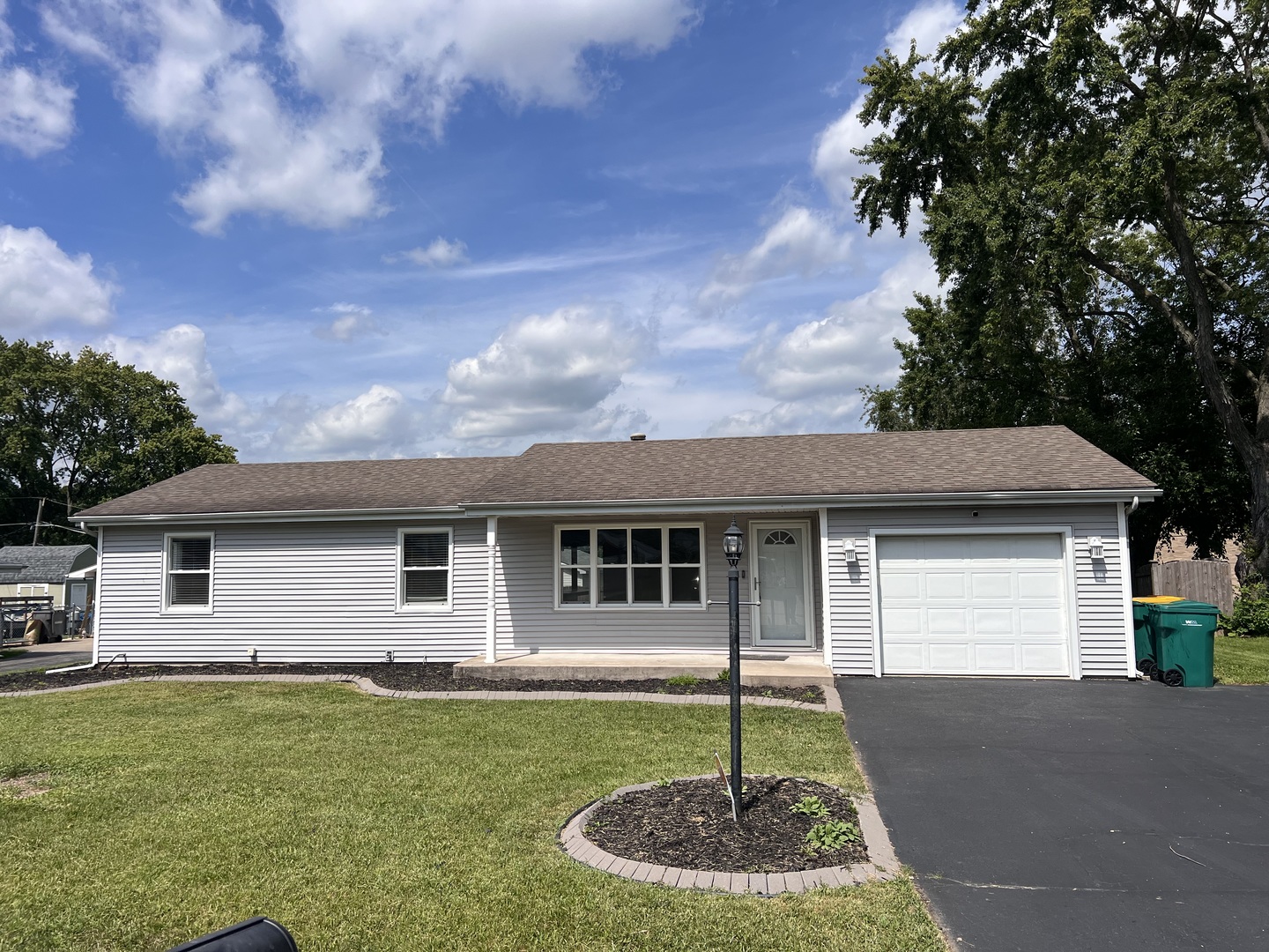 This updated 4-bedroom, 1.5-bath ranch offers space, style, and storage. Enjoy the oversized 20x18 family room with vaulted ceilings and walls of windows, flooding the space with natural light. The modern kitchen flows into a cozy eating area. LVP floors run throughout. A private bedroom wing and dedicated laundry/mudroom add function and flexibility. Attached 1.5-car garage with loft and attic access for ample storage. Step outside to a fully fenced backyard oasis featuring mature trees, a paver patio, storage shed, and outdoor fireplace-perfect for entertaining. Additional perks include gas forced heat and central air. A rare combination of comfort and charm-don't miss it!