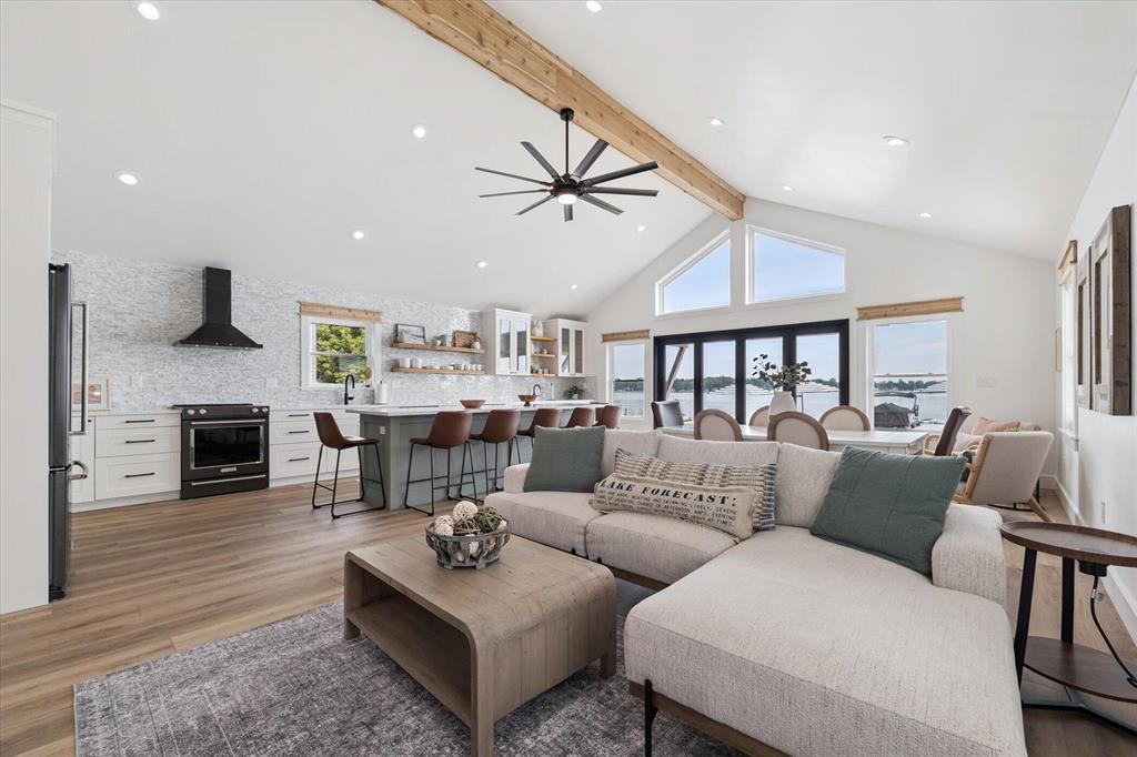 Brand-New Turn Key Waterfront Paradise on Portage Lake  Imagine waking up to the shimmer of morning sun dancing across Portage Lake, coffee in hand, from the patio of your brand-new lakefront retreat. Here, every day feels like vacation.This newly built, fully finished home is designed for gathering, relaxing, and making memories. With five spacious bedrooms--including two serene primary suites--and four luxurious baths, everyone has their own space to unwind. The open-concept living area brings the outside in, with accordion doors framing breathtaking water views.Step outside and stroll down to your large private dock, where your boat is ready for an afternoon on the water. With 800 feet of lake bottom ownership, you're not just living by the lake--you own a piece of it.
