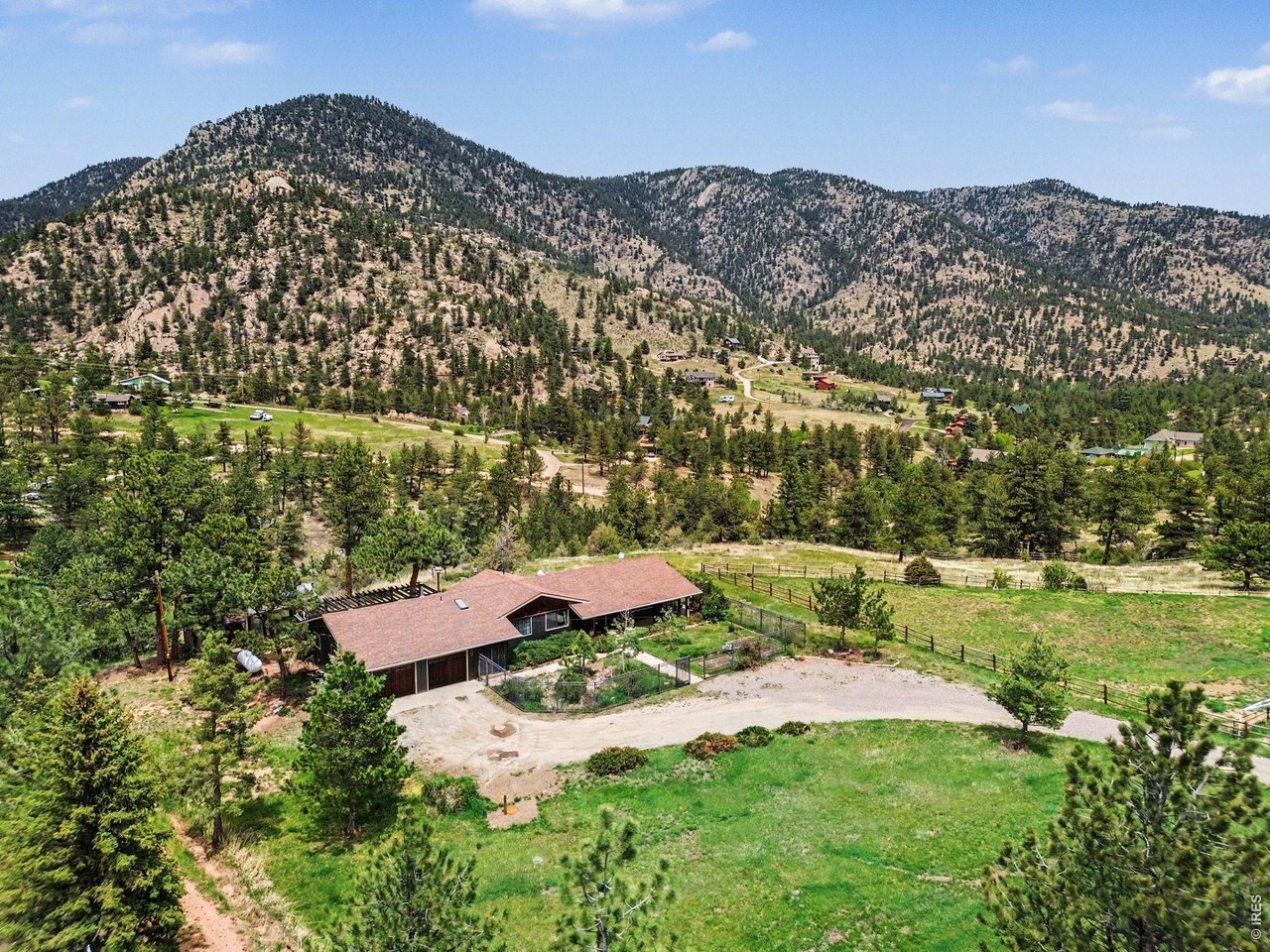 Sunny mountain meadows lead you home! This lovingly cared for and updated home has so much to offer. Artistic elements inside and out, combined with the open floor plan, generous windows, French doors, wrap around covered porches & decking nicely engage you into the mountain living experience. Mason crafted stone fireplace and wood mantle is the centerpiece of the living room. Artison Shop designed and built kitchen with gas cook top, granite counters, double oven and picture window with mountain views. Versatile second living space off of the primary bedroom with classic woodstove, deck access, wood floors and stained-glass accent window-- could be used as a den, home office or expanded primary bedroom. New carpet throughout. Situated on a level portion of the lot, giving room for a greenhouse, flower gardens, raised beds, fruit trees, easy traverse and use. Property has its own well. National Forest flanks the community on all four sides with miles of trails to enjoy it. Community has high speed internet, cell reception, shorter commutes, modest elevation and well-maintained roads that altogether make mountain living here the easy choice!