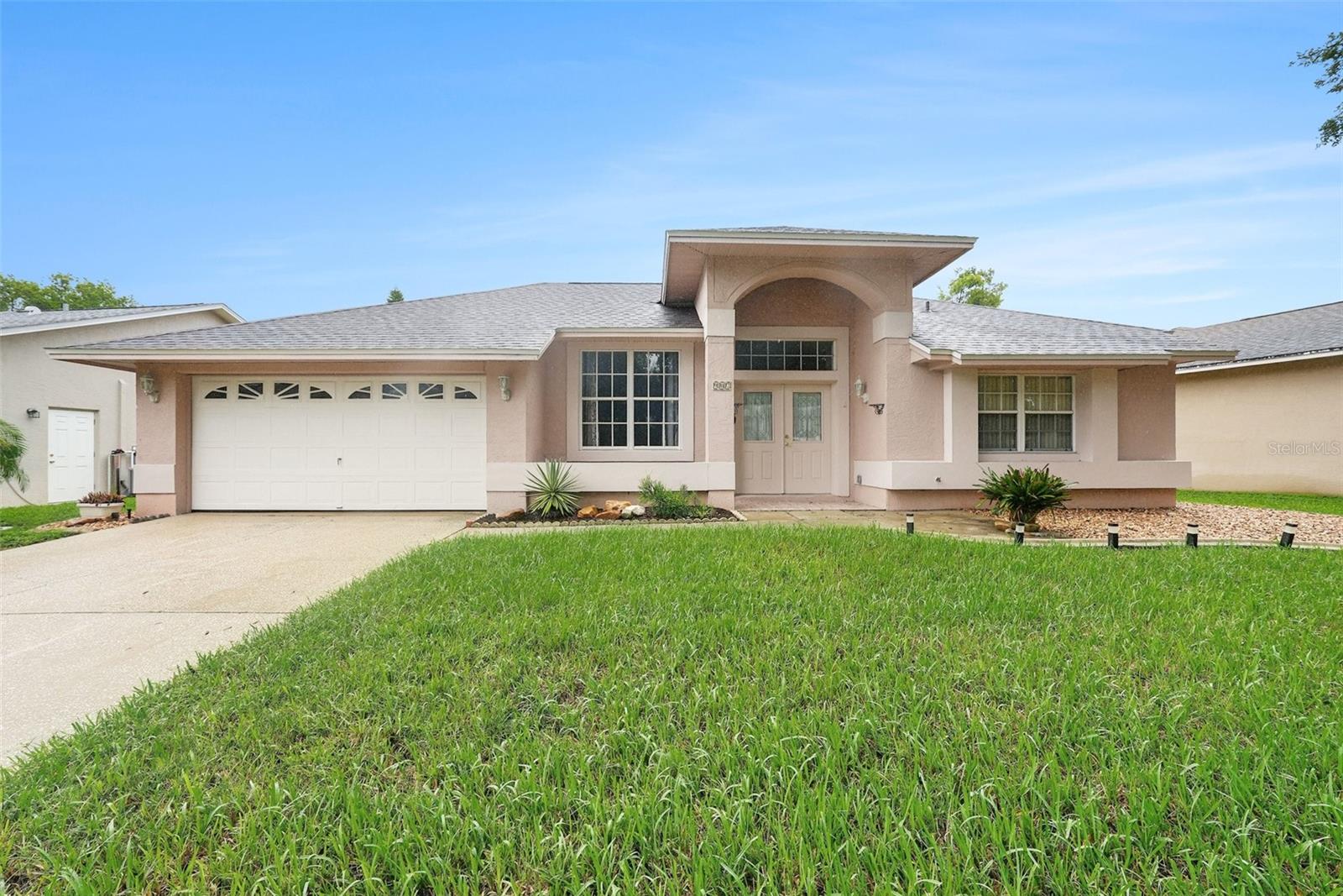 Experience the charm of this beautifully appointed 4-bedroom, 2.5-bath residence nestled in highly sought-after Tarpon Springs. Showcasing a bright, open-concept layout, this home features a chef-inspired kitchen complete with a stylish backsplash, abundant cabinetry, and a convenient breakfast bar perfect for casual dining. Soaring high ceilings enhance the spacious feel throughout, while the dedicated indoor laundry room and oversized 2-car garage add everyday convenience. Step outside to your own private oasis—an expansive screened-in lanai overlooking a sparkling inground pool, ideal for year-round entertaining. Perfectly positioned near major shopping, top-rated schools, local parks, Gulf beaches, and the vibrant historic downtown Tarpon Springs and famous Sponge Docks, this home offers the ultimate blend of comfort and location. A rare opportunity—make this exceptional property yours before it’s gone.
