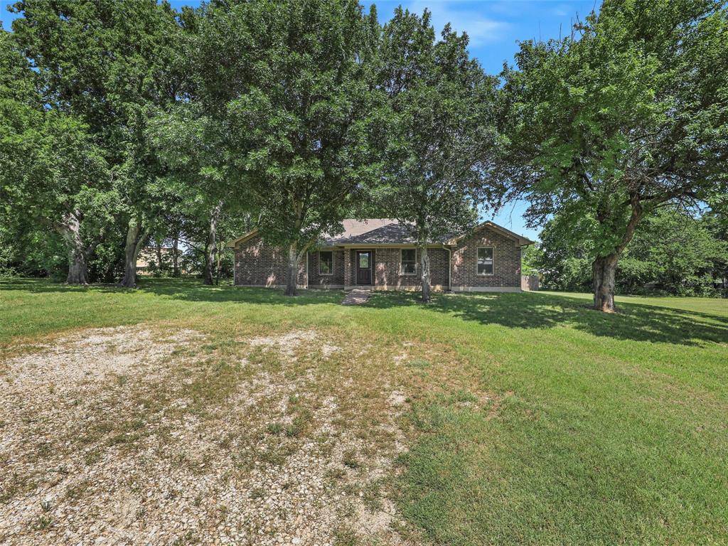 Serene Country Living on 2.17 Acres** Welcome to your dream home!This stunning 4-bedrm, 2-bathrm residence sprawls over an impressive 2,069 SQFT, perfectly situated on 2.17 acres of picturesque land.Nestled amidst lush pastures a & majestic shade trees, this property offers a secluded escape without sacrificing modern comforts. As you enter, you’ll be greeted by an inviting open flr plan that seamlessly connects the spacious living area, breakfast area and the gourmet kitchen. The kitchen boasts sleek stainless steel appliances, ample cabinetry, & a pantry for all your storage needs, making it a chef's delight. The generous living rm features a cozy wood-burning fireplace, perfect for gathering around during those chilly evenings. The primary bedroom is a true sanctuary, featuring extra large dual walk-in closets & a luxurious ensuite bathroom. Pamper yourself in the double shower or relax at the dual sink vanity, offering both style & convenience. Three additional well-appointed bedrooms provide plenty of space for guests, complemented by a thoughtfully designed secondary bathroom. But that’s not all! This property also includes approx, 300-SQFT apartment-office space equipped with its own kitchenette and full-bathroom-stand-up shower-, Electric HWH, ideal for guests or even as a rental opportunity. The INSULATED workshop with wood burning stove, complete with electricity and water, is perfect for hobbyists or anyone needing extra space for projects. Step outside to appreciate the vast outdoor space, where you can enjoy endless possibilities—Many features including: Fiberoptic, Low-E Anderson Windows, Awning 30x60. whether you envision lush gardens, recreational areas, or even horse pastures. The tranquil environment combined with modern amenities creates a perfect harmony, making this property a rare find.Don’t miss your chance to own this extraordinary oasis—schedule your private tour today & envision the life you could be living on this magnificent property!