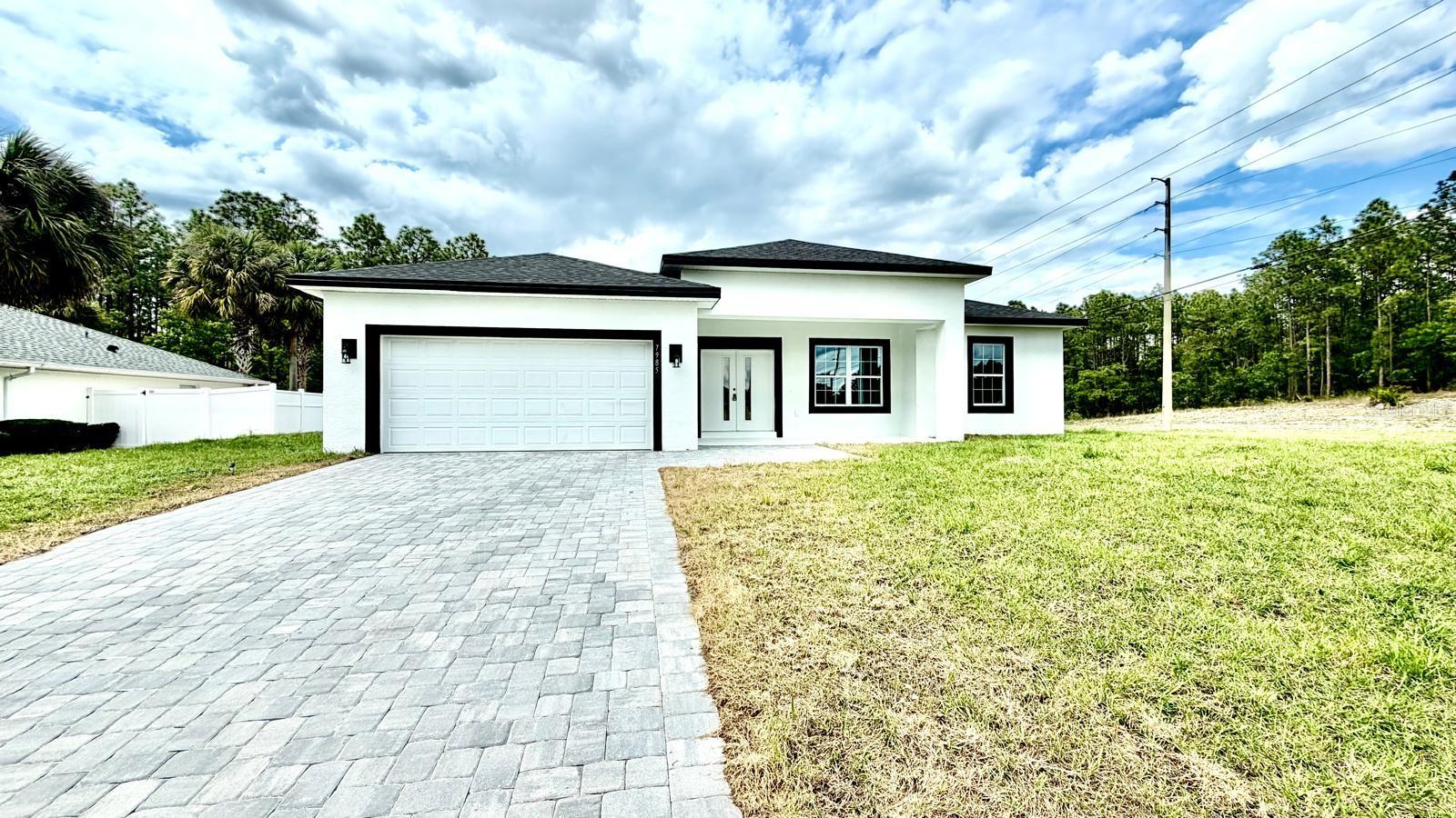 “Welcome to an exceptional opportunity to own a beautifully crafted home that combines quality construction, thoughtful design, and incredible value. From the moment you step through the front door, you are welcomed into a bright, open, and inviting space where natural light flows effortlessly and high ceilings create an airy, expansive feel.The heart of the home features a modern kitchen with stone countertops, stainless steel appliances, and a spacious island perfect for gathering and entertaining. Every detail has been carefully considered to create a space that feels both functional and refined.The primary suite offers a true retreat, complete with an elevated soaking tub and a spectacular walk-in shower designed like a showroom, featuring dual shower heads for a spa-like experience.Additional highlights include ceramic tile flooring in the main living areas, Kitchen and bathrooms with Quartz comfortable bedrooms, and a garage with a professionally finished epoxy floor enhanced with decorative flakes, adding both durability and style.Built with solid concrete block construction and designed for modern living, this home stands out as a well-executed, light-filled, and beautifully finished property. Located on a desirable corner lot with convenient access to major roads, shopping, and dining, this is a rare opportunity you don’t want to miss.”