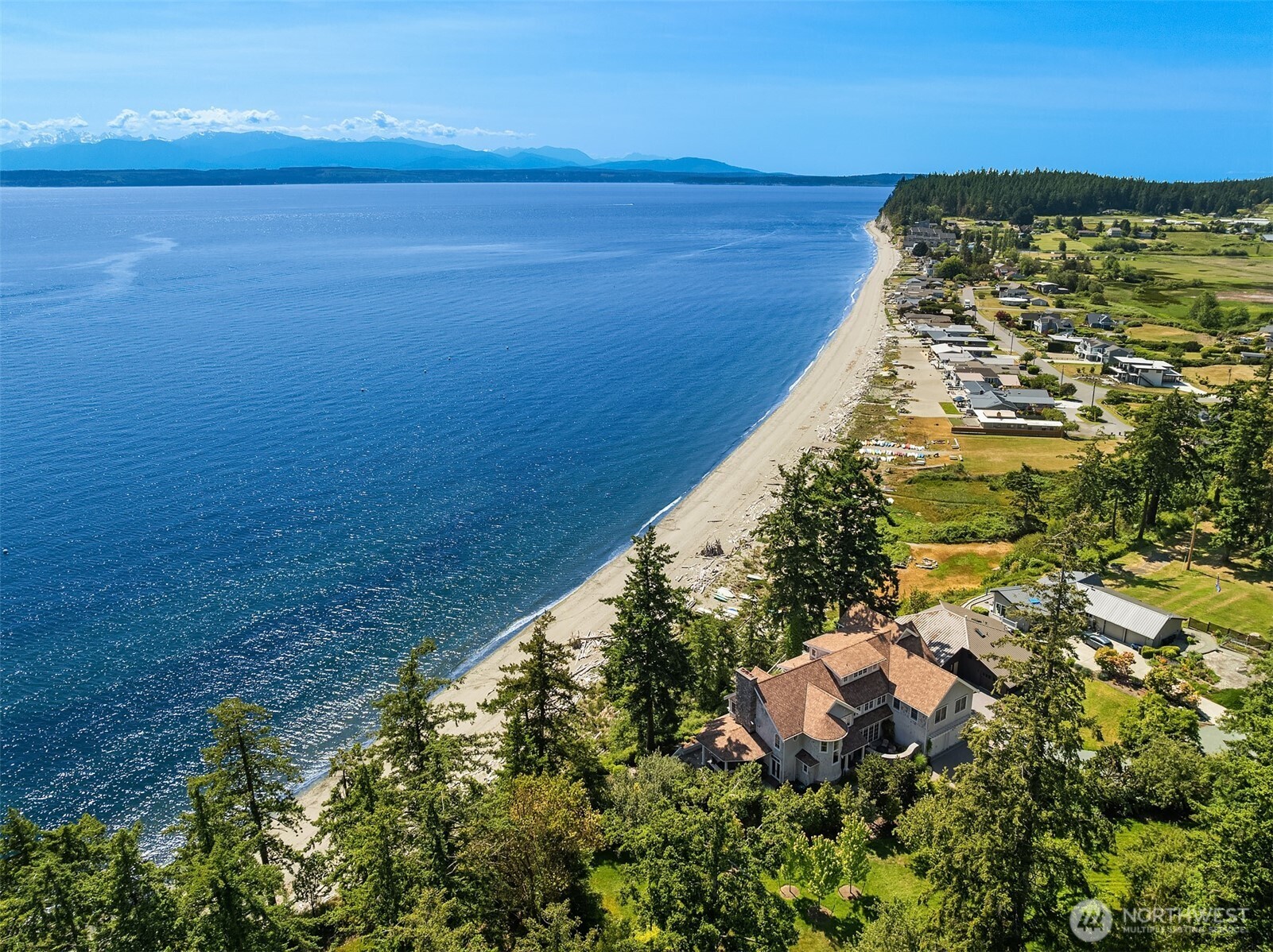 Quintessential Coastal Living on Mutiny Bay. Enjoy sweeping western views & the ultimate in privacy from this beachside retreat. Incredible craftsmanship over 6,100 sf of gracious living. A floor plan designed to entertain & host friends. Expansive great room, kitchen & family room with awe-inspiring views of water & the Olympic mtns. Dining room for 10+, covered outdoor living. Relax fireside as the sun sets. Hot tub, firepit & the coveted wide, sandy beach for endless play & chasing the sun. Four bedroom view suites, including luxurious primary w/vaulted ceilings, fireplace & deck. Upper level with spacious exercise room, spa, deck & loft. Media room & more. Nothing missing at this incredible estate where every day is a vacation.