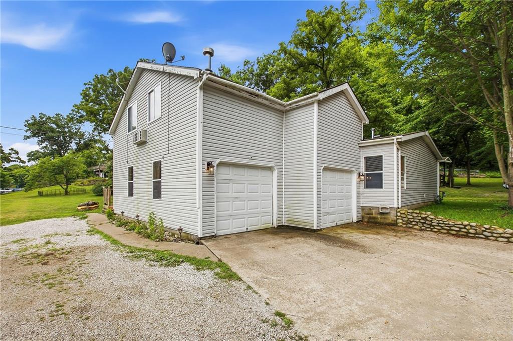 You won't find a more level first-tier property at Lotawana.  This home is located close to Hwy 7, allowing easy access on and off the lake—on two lots, 159 and 160, East of the lake road.  There is a possible 4th bedroom suite upstairs, and another possible primary bedroom suite downstairs once the third bathroom is finished.  The upstairs room functions as a family room.  Once a door is added, you could have a 4th bedroom.  This would be a great starter home with a little TLC.  It has a nice-sized swim dock in good water.  The HOA is scheduled to dredge this cove, which will make the water depth even better.