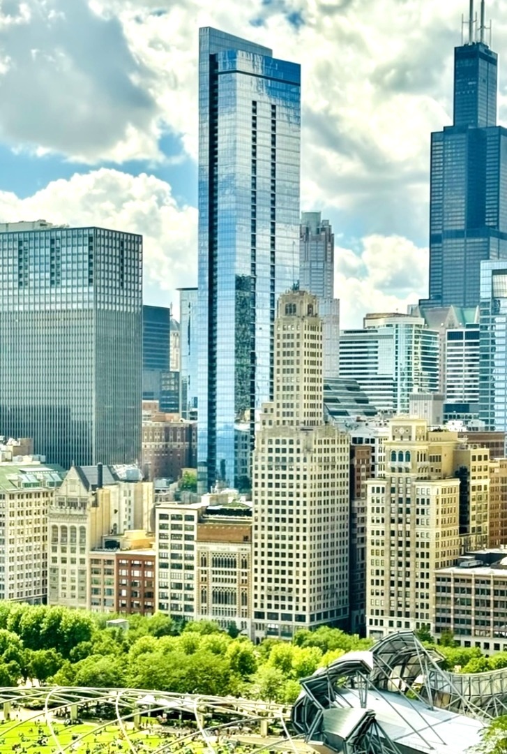 Legacy at Millennium Park is an iconic skyscraper designed by SCB. There are only 15 of these most sought-after Millennium 01 northeast corner units. Unit 5601 offers stunning waterfront views with ideal vantage points for taking in Chicago's iconic skyline, including Monroe Harbor and Buckingham Fountain. You can see all the way to Indiana and Michigan. From the moment you walk into the Foyer, you are enchanted by the views led on by the 60ft wrap-around window. The owner exquisitely designed this beautiful home in the sky. The living room features a custom-built wall unit with LED lights. Complemented by a circular cove ceiling with LED lights, the designer completes the look by adding a Xanadu chandelier for the dining area, a great place for Navy Pier's fireworks nights. Continued to be wowed by this cool and sumptuous kitchen, the style speaks volumes to those who appreciate architectural elements, features luxury Italian Snaidero cabinetry (showcase at the Merchandise Mart)with stainless steel pulls, paired with quartz countertops that exuding the subtle strength of monochromatic colors. The kitchen is equipped with Wolf stainless steel cooktop/built-in oven, hood vents out, a Sub-Zero fridge, a Miele dishwasher, a Wolf built-in microwave, and a warming drawer. The custom designed cantilivered island bar is perfect for entertaining. A nearby custom home bar area features a wine fridge. The recessed balcony is a great place to watch the sunset. Spare no expense, the owner's most recent renovation added stunning Liston Milano imported wide plank hardwood floors (Biancospino) with natural stains. Lutron power shades throughout, plus a central control zone. All bedrooms offer stunning lake and skyline views. Home Audio systems and surround sound in every room. Newly painted, Sherwin-Williams. The primary en-suite is spacious with lake/skyline views, it features a den space with a custom-built wall unit desk/vanity, a large walk-in closet with custom-built-in drawers and wardrobes. The primary bathroom is an oasis, featuring a double vanity, modern wall sconces, a large shower with a beautiful feature wall, and a 6-foot air-jet soaking tub, with white marble tiles and a water closet area with chrome warming towel bars. The large mud room offers ample storage, equipped with washers and dryers. The second bedroom en-suite is spacious with a beautifully designed bathroom with natural stones. The third bedroom, located across from the third hall bathroom, features gorgeous mosaic flooring. All closets and storage have built-in shelving. This central location offers world-class living experiences, you can walk everywhere to the West Loop, Mag Miles, Theatres, Symphony, Art Institute, and pickleball, the fun list goes on. Accessable to pedways. Excellent condo management team and 24-hour doorman service, a health club featuring a fitness room, a 2-lane heated pool, a large whirlpool, and steam rooms. In-house valet/dry cleaning services, a package room, plus indoor dog-walk area. Moreover, this premier "A" building has a sky bridge connecting to the elite University Club of Chicago, a private club with world-class hotel service offering fine dining, room service, and full sports/spa amenities. There are golf simulators and five squash courts (optional membership available)! Enjoy an easy 3-minute walk to the lakefront jogging/bike path. 2 parking spaces are available for purchase, one located on the 4th flr close to elevator.