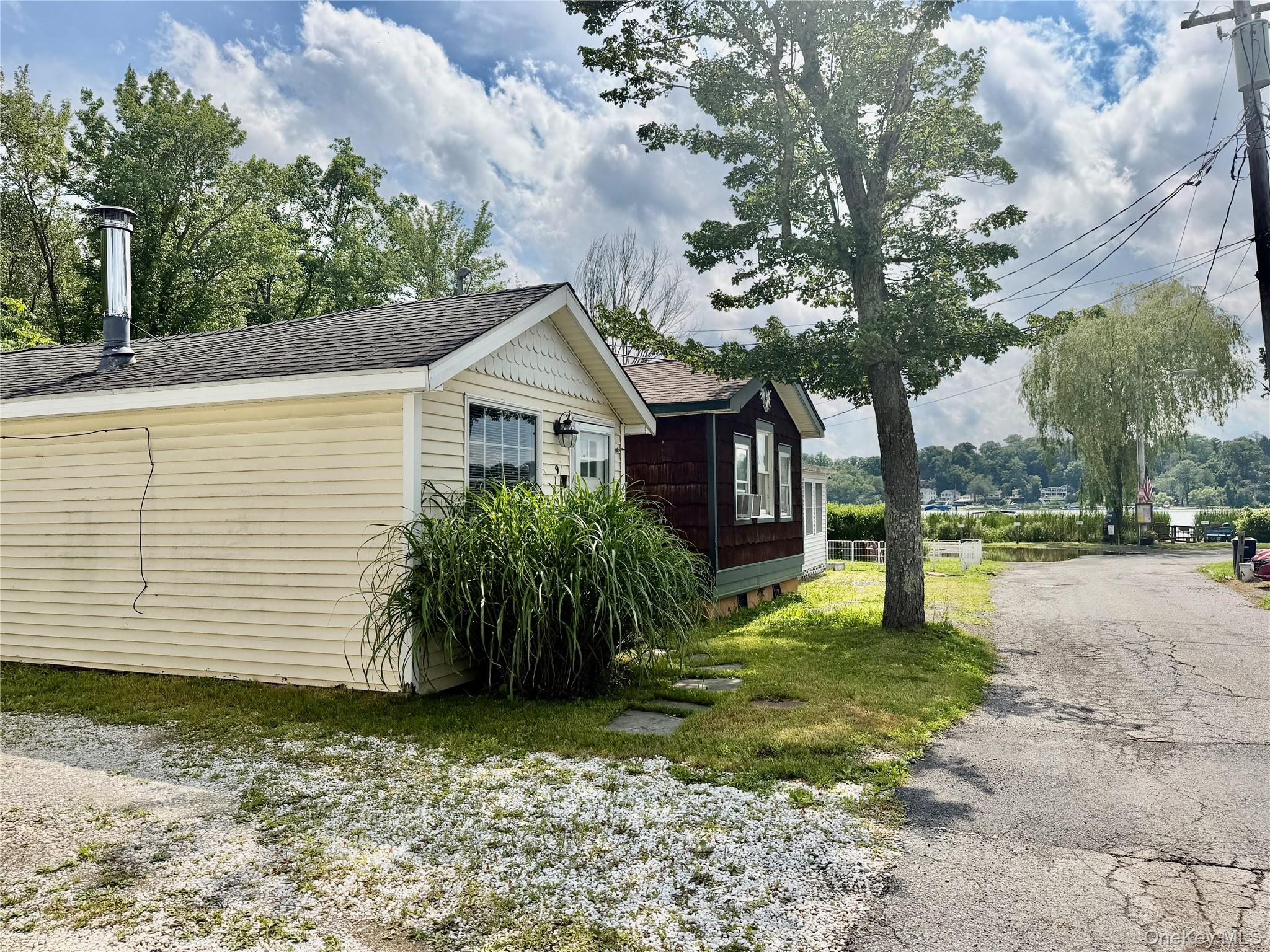Enjoy this Cozy 1 Bedroom Dream Home in a Lovely Lake Front Community on Peach Lake. This home was totally renovated from top to bottom, fully insulated, roof, windows, & flooring, mini split heating and A/C system, skylight, cathedral ceilings, ceiling fans, & custom lighting.  It also features a Wood-burning stove set in a Stone Fireplace, a Beautifully Designed Custom Kitchen, and a Custom Tiled Bathroom.  Step out your front door to see the Gorgeous Lake Views and Sunsets Views over Peach Lake. This home is move in ready! The community features a private beach, picnic area, playground, basketball court, softball field, and clubhouse. Enjoy a lakeside community.  Located minutes from Golf course, an Equestrian Center, Restaurants, I-684, I-84, & Metro North.  Co-op board application & approval are required.