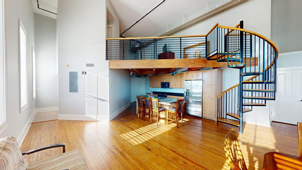 Stunning Downtown Thomasville Loft in the Historic Mitchell House.  Discover upscale loft living in the heart of Thomasville, Georgia. This exceptional residence—set within the iconic Mitchell House—offers the perfect blend of historic charm and modern comfort.  Step inside to soaring 19-foot ceilings, pine flooring, exposed beams, and industrial-style exposed pipework that create a dramatic, open atmosphere. The spacious layout includes two bathrooms and thoughtfully designed living areas filled with natural light.  Enjoy access to a rooftop deck, ideal for relaxing, entertaining, or taking in downtown views. From your front door, you're just a short walk down Thomasville's beloved brick-lined streets to shops, dining, and all the character the downtown district has to offer.  Experience the best of historic elegance and contemporary style—this unique loft is truly one of a kind.