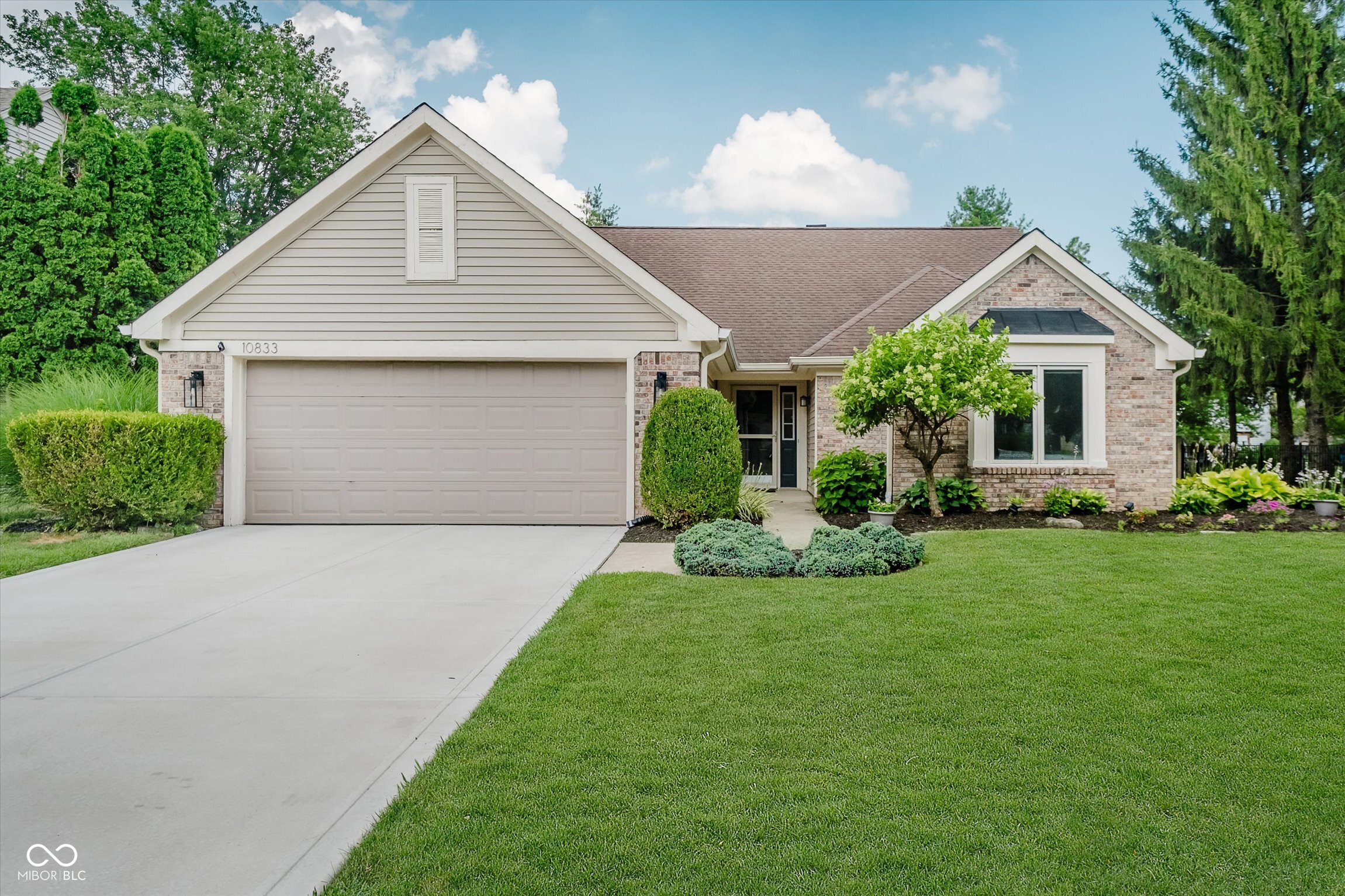 Welcome to your dream home at 10833 Davis Way, in one of the most desired locations in heart of Fishers. Close to restaurants, shops and a city park with outdoor concerts, this is the perfect location. This lovely 3-bedroom, 2-bathroom has been beautifully updated and  is move in ready. The backyard is so tranquil with a sun porch that overlooks the perfect fully fenced backyard, a great deck and a peaceful water feature, it is an outdoor oasis right in the middle of the city. New interior paint and updated light fixtures. The floorplan is open and airy living space with a 2 sided fireplace, open from the great room into the kitchen. Vaulted ceilings with skylights keep the home bright and sunny. The dining area has a huge new window. New recessed lighting. The heart of the home, the kitchen, boasts a stunning new quartz island with fresh paint on the cabinets and a brand-new refrigerator. The spacious primary bath has been fully remodeled, offering a luxurious retreat where you can unwind after a long day. Each bedroom is designed with comfort in mind, providing ample space for relaxation. Additional features of this delightful home has a freshly landscaped yard and new driveway. Plus stay comfortable year-round with the newly installed furnace and A/C checked in 2024.  Don't miss the chance to make this beautiful house your home.
