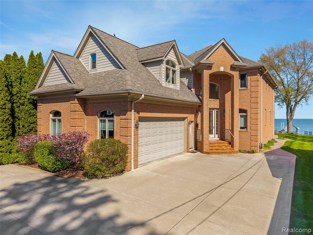 Experience luxury lakefront living in this one-of-a-kind custom-built home on Lake St. Clair, where no expense was spared and timeless craftsmanship shines. Offering 4 bedrooms, 3 full baths, and 3 half baths, this exceptional residence features soaring ceilings in the great room and foyer, along with expansive lake views from most rooms. The main level is designed for comfort and entertaining, with a chef’s eat-in kitchen, first-floor laundry, private office, and cozy den with stunning water views that can be closed for added privacy.Upstairs, the incredible second-level primary suite is a true retreat with two walk-in closets, an oversized shower, jetted tub, and private covered balcony overlooking the lake. Two additional bedrooms share a full bath on the second floor, along with a workout room and ample storage. The third-floor bedroom/hangout is perfect for guests or kids, offering panoramic lake views plus a large clean attic for more storage.The fully finished basement is an entertainer’s dream with a full pub, movie theatre, game room, fireplace, projection screen, and unique features including a powered pool table light that raises for table tennis, plus a convenient powder room. Basement access is available from both the home and attached heated garage.Outside, enjoy a detached heated second garage with half bath and finished loft space above, a whole-house generator, sprinkler system, outdoor shower, tiki bar, and updated boat hoist for at least a 40-foot boat, plus two newly installed jet ski/dinghy lifts. Deep water makes boating effortless, even in low-water years.With too many custom upgrades and features to list, this home is a must-see for anyone seeking luxury lake living. Just north of St. Clair Shores with lower township taxes, currently non-homestead. Ideally located near waterfront restaurants, bars, and shops accessible by land or sea—this is a rare Lake St. Clair gem built to last.