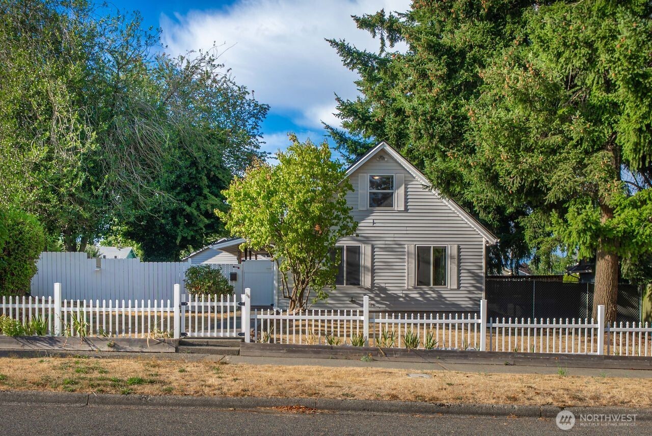 Don't miss this move-in-ready 2 story craftsman in a desirable Tacoma neighborhood! This charming 3-bedroom, 1-bath home features newer flooring in the throughout, and fresh interior paint. Double-pane windows help keep the home comfortable year-round. The cozy open concept  adds warmth and character to the living space, while the fully fenced backyard offers plenty of room for pets, play, gardening, or entertaining. A detached two-car garage plus carport provides convenient parking and additional storage. Located on a quiet street surrounded by well-maintained homes and evident pride of ownership, this property combines comfort, value, and convenience with easy access to shopping, schools, parks, and commuter routes. Ready for immediate occupancy—come see all this home has to offer!