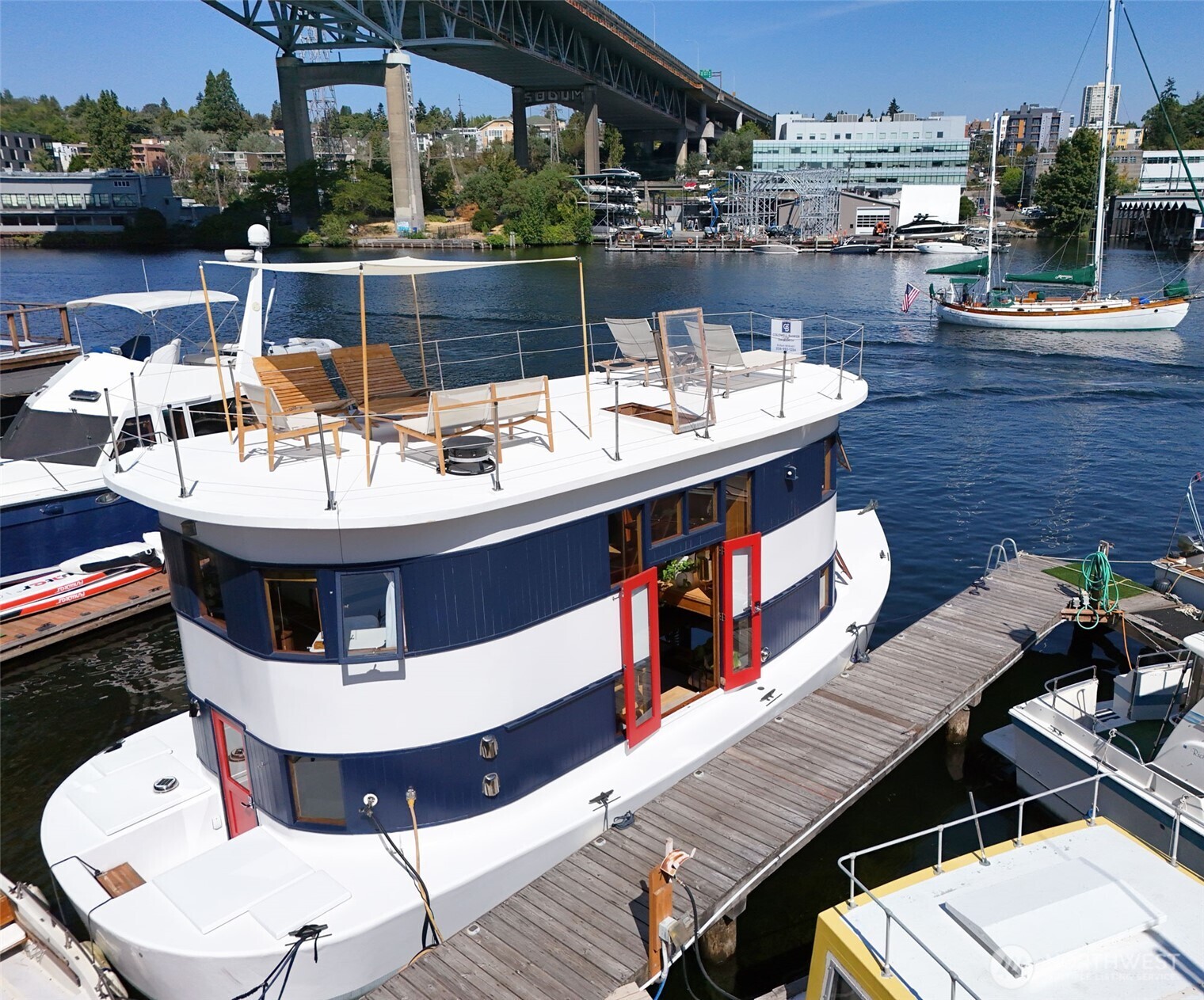 Welcome to Andante, a spacious 2BR/2BA plus den houseboat w/ loads of recent upgrades, conveniently located in the Eastlake/Portage Bay neighborhood(s) just across the bridge from the University of WA.  Enter through bright French doors to your completely renovated kitchen w/ new cabinets, Corian counters, high-end appliances, pantry, rafter wine rack & thoughtful filtered-water station--bar seating, open concept & built-in dining make this a great entertainment space that flows into your wood-wrapped living area w/ a gorgeous beam ceiling & curved windows to enjoy your direct Lake view. Ensuite laundry & full bath on main level. Upstairs you'll find a perfect home office space, 2nd bedroom w/ Murphy bed to maximize utility/flexibility & luxurious main bedroom w/ ensuite bath and wrap-around views that make you feel like you're relaxing on vacation every day.  Interior stairs to your large completely new roof deck make a great private oasis or entertainment space to share this magical experience with friends! Space for your accessory boat for you to enjoy the Lake or tie up at one of the many nearby restaurants. Lots of transit nearby including Lightrail station! City-registered FOWR 877.