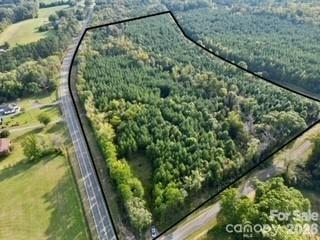 Beautiful 23-acre wooded property offering privacy, natural beauty, and convenience. Located at the corner of Hwy 52 and Southbound Rd with substantial road frontage on both roads. The land features mature loblolly pines, well-defined trails, and scenic Jacobs Creek running through the property.Perfect for nature enthusiasts or anyone seeking a peaceful retreat. Ideal for hiking, hunting, camping, or building your dream home surrounded by nature. Rear boundary runs along railroad tracks parallel to Hwy 52, adding unique character.