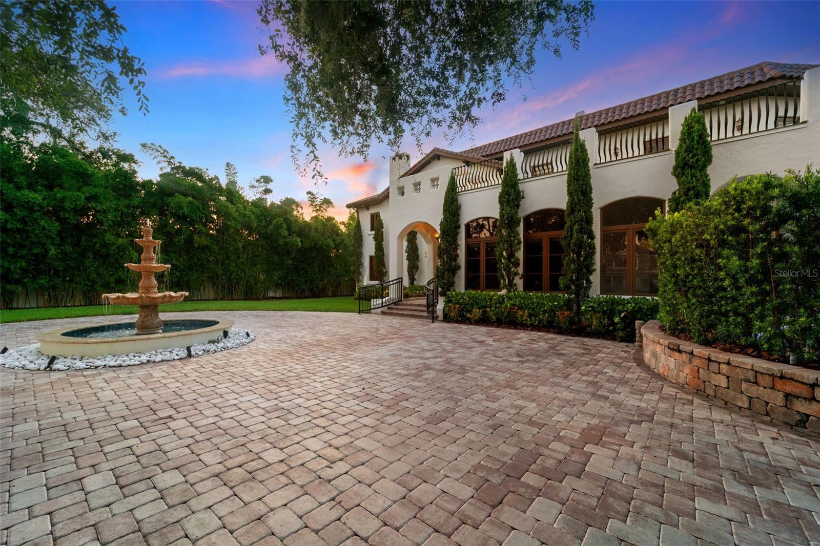 One or more photo(s) has been virtually staged. Welcome to 4555 W Swann Avenue - a showstopping Mediterranean estate nestled in Tampa’s prestigious Beach Park neighborhood. Built in 1925 and exquisitely renovated, this architectural masterpiece blends historic charm with unmatched modern sophistication. Situated on an oversized lot behind a gated circular drive with a centerpiece fountain, this home offers over 6,800 square feet of resort-style living. The home boasts 5 bedrooms, 5.5 full baths, multiple living spaces, and both upstairs and downstairs laundry rooms for optimal convenience. The 1,000+ sq ft primary suite is a true retreat, complete with a private sitting area, fireplace, wet bar, dual designer closets - including a custom purple-glam dressing room - and a spa-inspired bathroom with statement soaking tub, makeup vanity, and expansive walk-through shower. Step outside to your private paradise: a luxury pool with a cascading waterfall, glowing iridescent tiles, and ambient lighting, all framed by tropical landscaping and a mosquito misting system. Entertain in the fully equipped outdoor kitchen, or unwind on the 1,500 sq ft turfed balcony that seamlessly extends your living space outdoors. The turfed side/back yard is packed with family-friendly luxury, featuring an in-ground trampoline, putting green with lighted holes, a dog run, and a custom cat cave - a whimsical and functional retreat for your feline family member. Inside, the chef’s kitchen stuns with dual-tone custom cabinetry, a massive center island, walk-in pantry, and designer appliances. The open-concept living and dining area is anchored by arched windows and flooded with natural light. Additional highlights include a 700-bottle wine cellar, large downstairs en-suite guest bedroom, bonus room, and multiple living spaces with fireplaces and custom millwork. Located in a top-rated school district and designed for both everyday living and grand entertaining, this home also features a transferrable roof warranty and has had no flooding or hurricane damage (Milton or Helene). Experience the ultimate in design, functionality, and location - just minutes from Westshore, Hyde Park, Tampa International Airport, and the city’s finest shopping and dining.