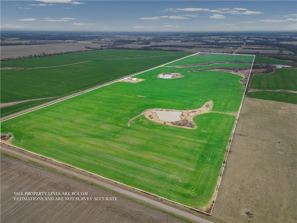 An exceptional opportunity to acquire 769 acres m/l of highly diverse farm and recreational land in Vernon County, Missouri. This expansive offering includes multiple tracts selling together, with all acreage situated within a contiguous four-section block, enhancing operational efficiency and overall manageability. The property features approximately 460 acres m/l of productive tillable ground, 37 acres of established pasture, approximately 26 acres currently enrolled in the CRP program, and approximately 200 acres m/l of mature timber, a significant portion of which lies along the Little Drywood Creek.The row crop acreage is currently leased through October 2026, providing immediate income and investment stability. The farm boasts considerable frontage along Little Drywood, creating exceptional wildlife habitat and natural travel corridors for deer and turkey. Portions of the timber include mature pecan trees, and the property has produced pecan harvests in past years, adding both character and seasonal income potential. Approximately four ponds provide reliable water sources for livestock and wildlife while enhancing the property’s recreational value.Improvements include a couple of older wooden barns that offer functional storage and the opportunity for restoration or repurposing. Utilities are available at the road including Barton County Electric, rural water, and natural gas, providing convenience and future development flexibility. With several outstanding building sites throughout the property, this tract presents excellent potential for a private residence, lodge, or multi-generational estate setting. Mineral rights are believed to be included, adding further long-term value.Whether you’re expanding a row crop operation, securing an income-producing agricultural investment, or seeking a premier hunting and recreational property, this tract delivers scale, diversification, and long-term potential