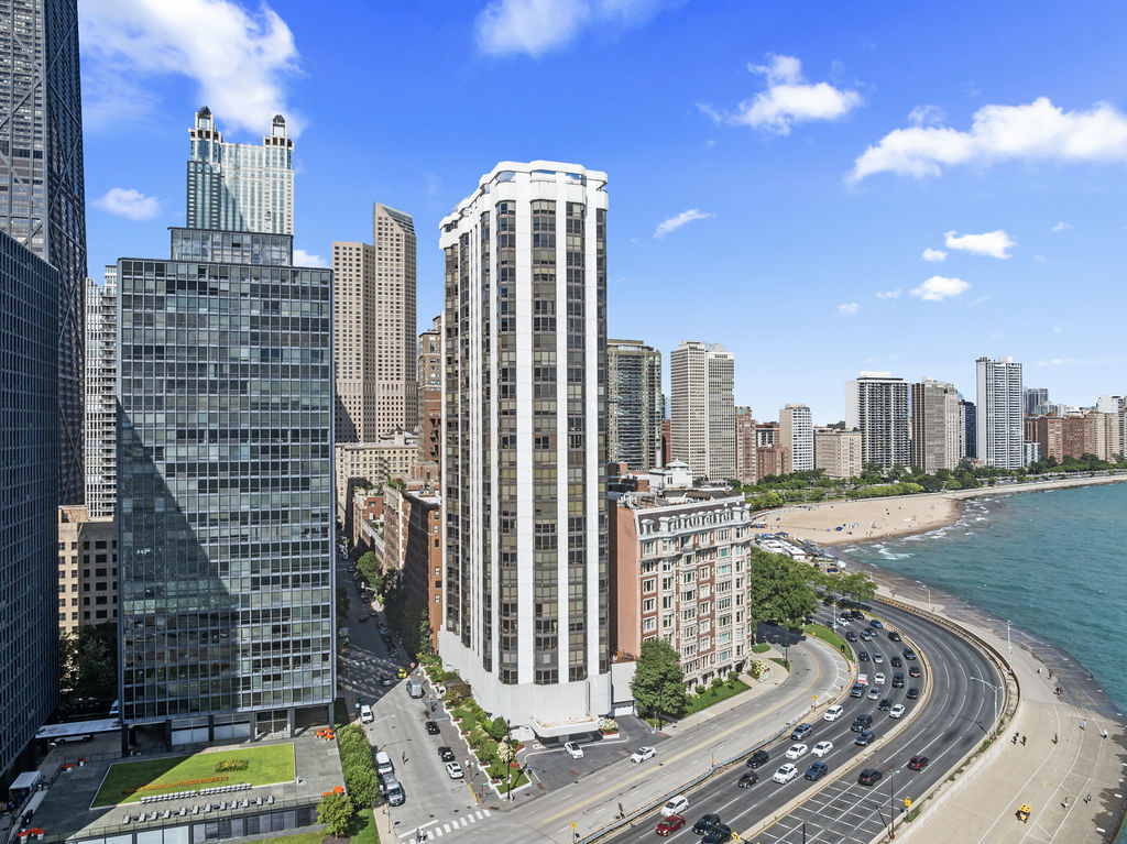 Luxury lakefront living awaits your creative eye! Indulge in panoramic vistas of Lake Michigan and Navy Pier from this distinguished 3 bedroom, 2.5 bathroom condo with approximately 2,000 square feet located in the prestigious 990 N. Lake Shore Drive condominium in Chicago's vibrant North Streeterville neighborhood. Nestled in the building's highly coveted southeast corner "A" Tier, this residence epitomizes a harmonious blend of sophistication and convenience with water views from every window and room. The open concept living and dining areas are thoughtfully designed for both relaxation and entertaining seamlessly blending into the spacious island kitchen boasting ample cabinetry, pantry and in-unit stacked washer and dryer laundry. The expansive primary suite is complemented by a generous walk-in closet, and the additional bedroom offers abundant space for family or guests. The third bedroom has been opened up to be a part of the living room and currently serves as a dry bar and built in entertainment center providing versatile living options. While elegantly appointed, this exceptional home presents a unique opportunity to infuse your personal touch with modern updates. The building features 24-hour door staff, an onsite manager, a luxurious rooftop pool and sundeck, an upscale club room, and a fully equipped gym are all part of the low HOA and tax. Leased attached garage with Valet and guest parking accommodates multiple vehicles, EV chargers and the building is pet-friendly, welcoming up to two pets per unit, including one dog up to 30 lbs. Schedule your private showing today to explore the potential of this exceptional AS-IS condo.