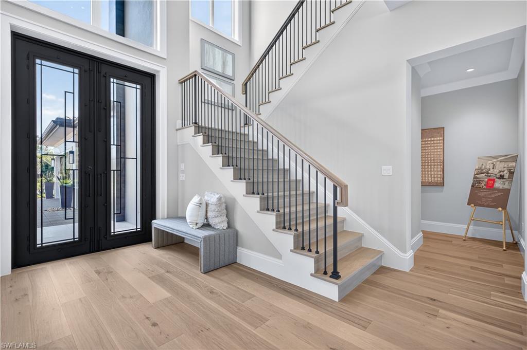 Foyer entrance featuring a high ceiling and light wood-type flooring
